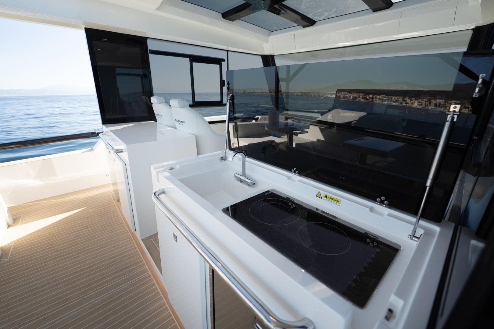 2026 De Antonio Yachts 50 Coupe interior with modern kitchen and ocean view.