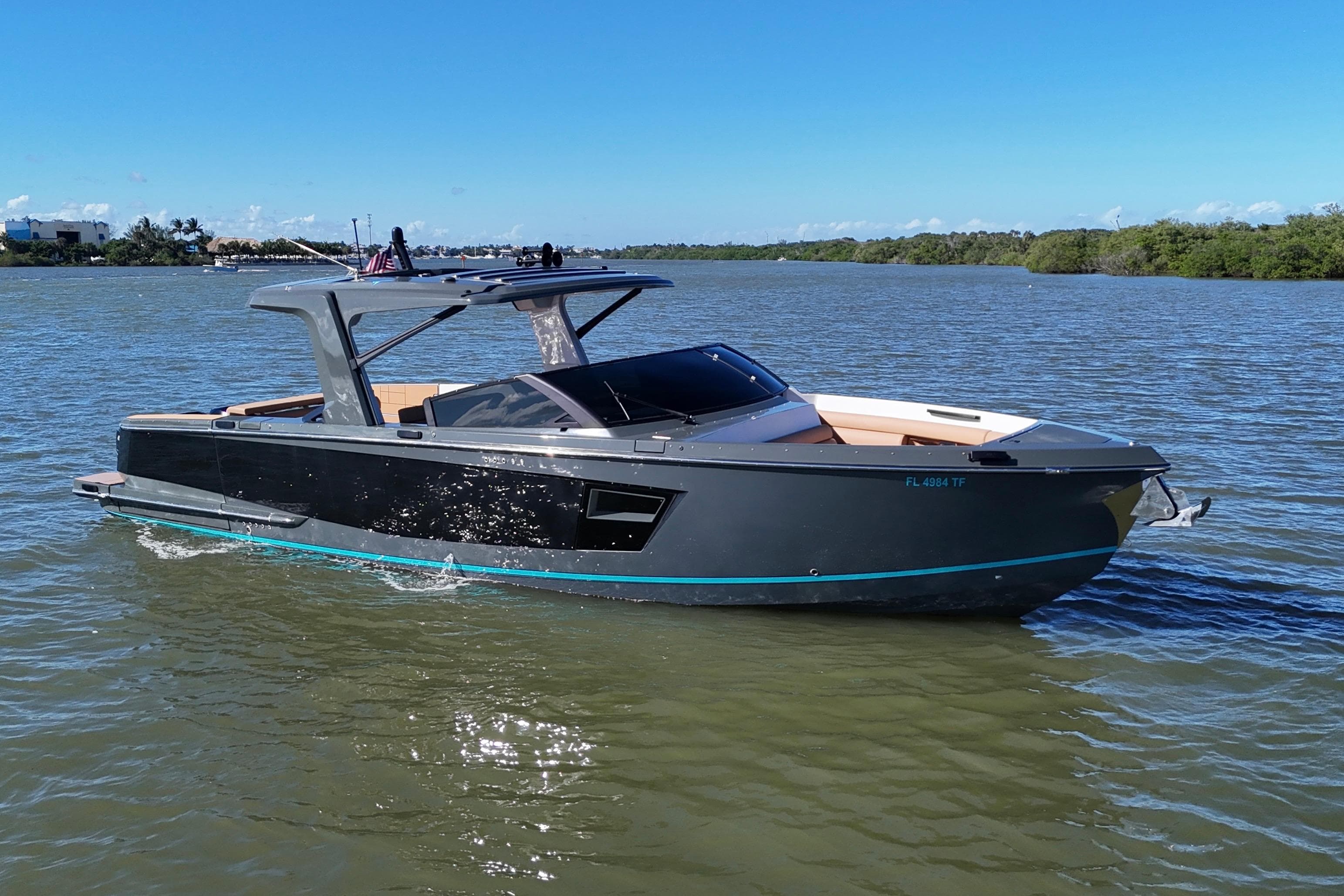 2022 Aviara AV40 OB boat cruising on a calm river under a clear blue sky.