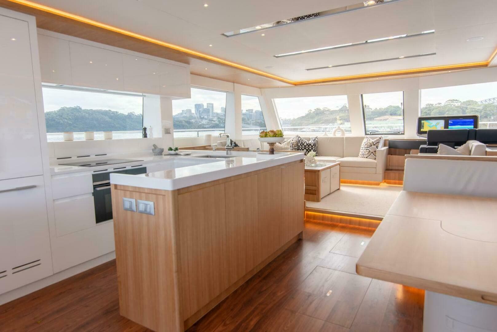 Luxurious interior of 2026 ILIAD 53F yacht with modern kitchen and panoramic windows.