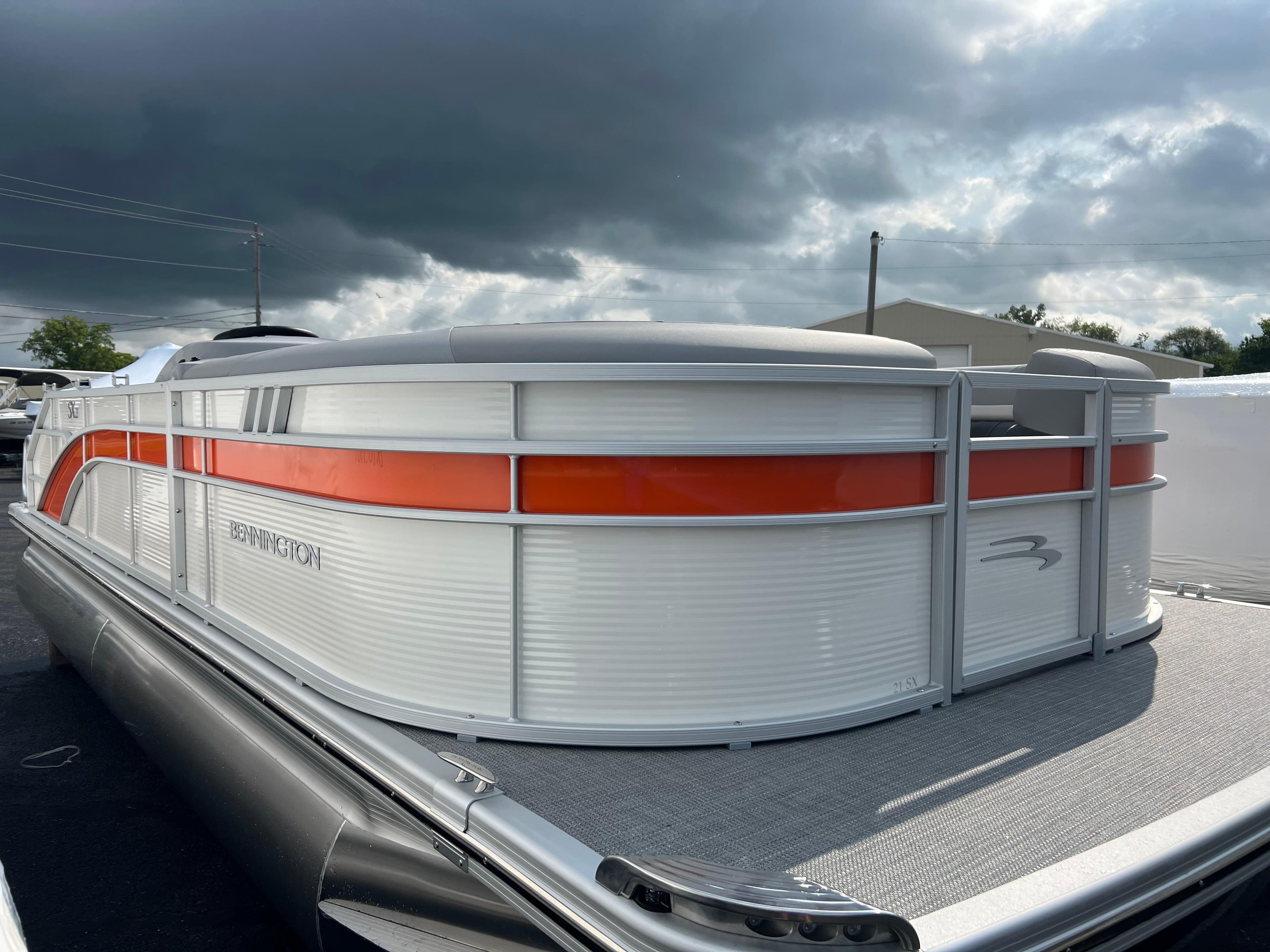 2025 Bennington 21 SXSB pontoon boat with orange and white exterior.
