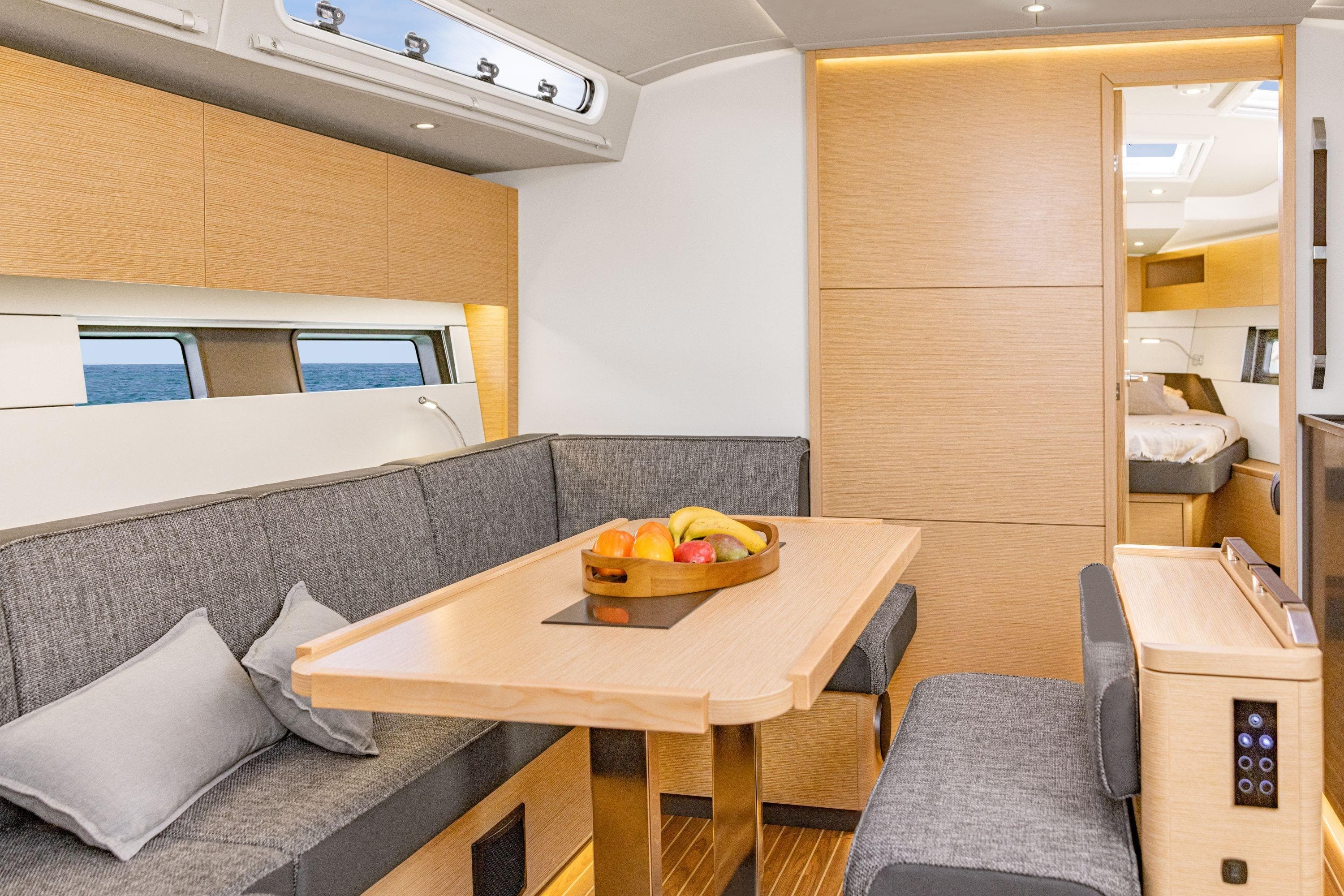Modern interior of 2026 Hanse 460 yacht with cozy seating and dining area.