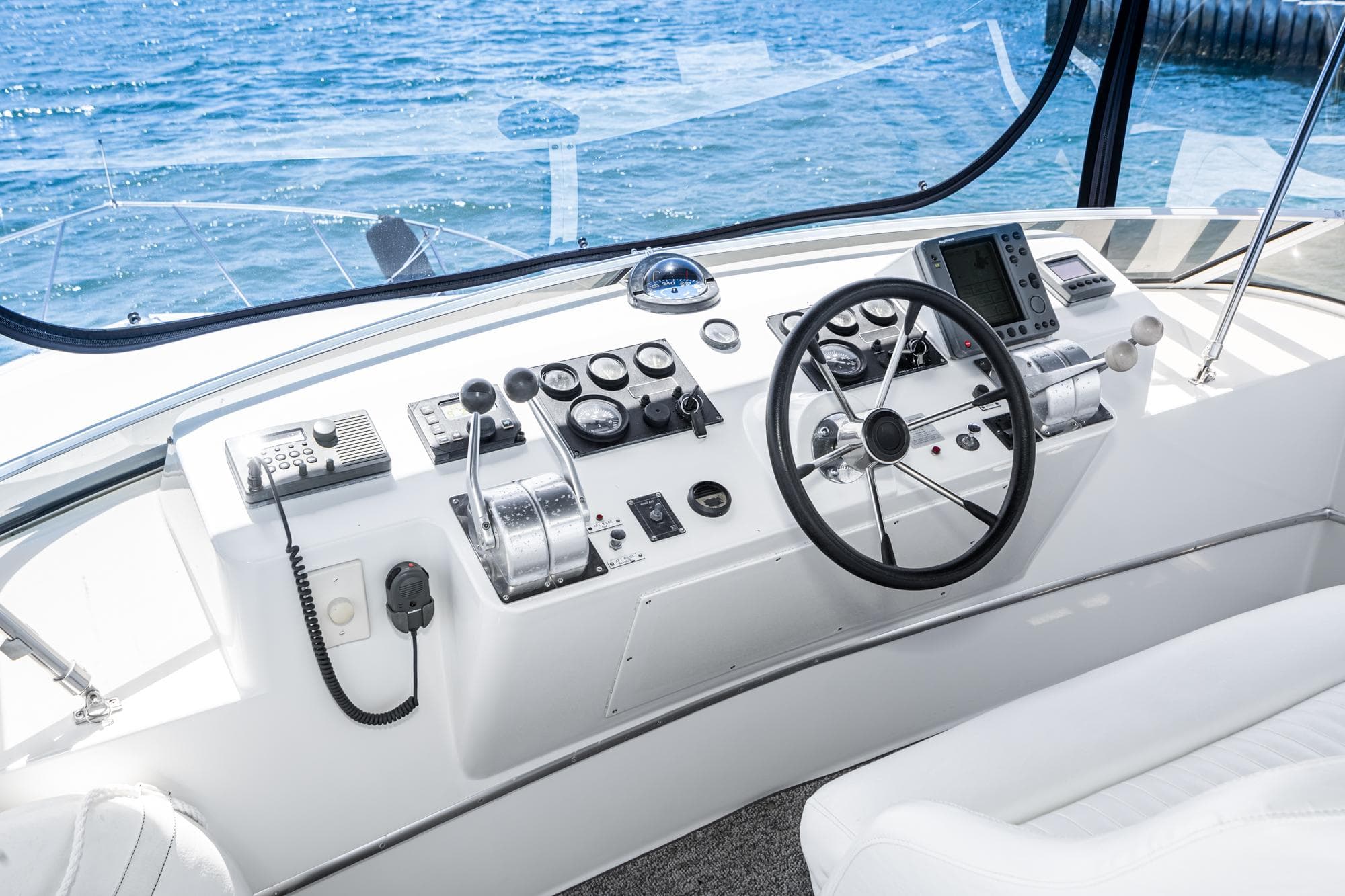 Helm of a 1999 Californian 3900 yacht on open sea.