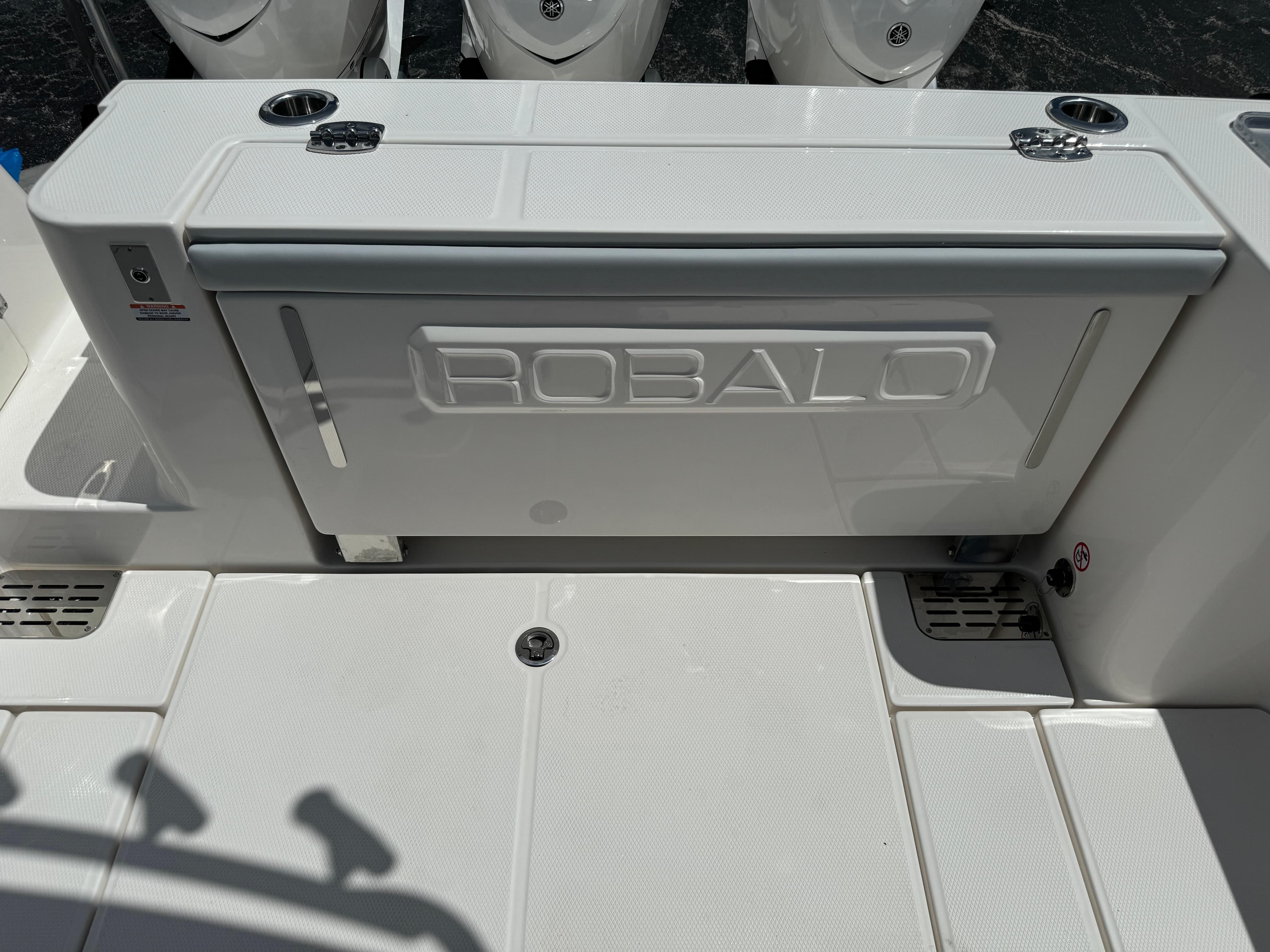 2025 Robalo R360 Center Console boat deck with storage compartment.
