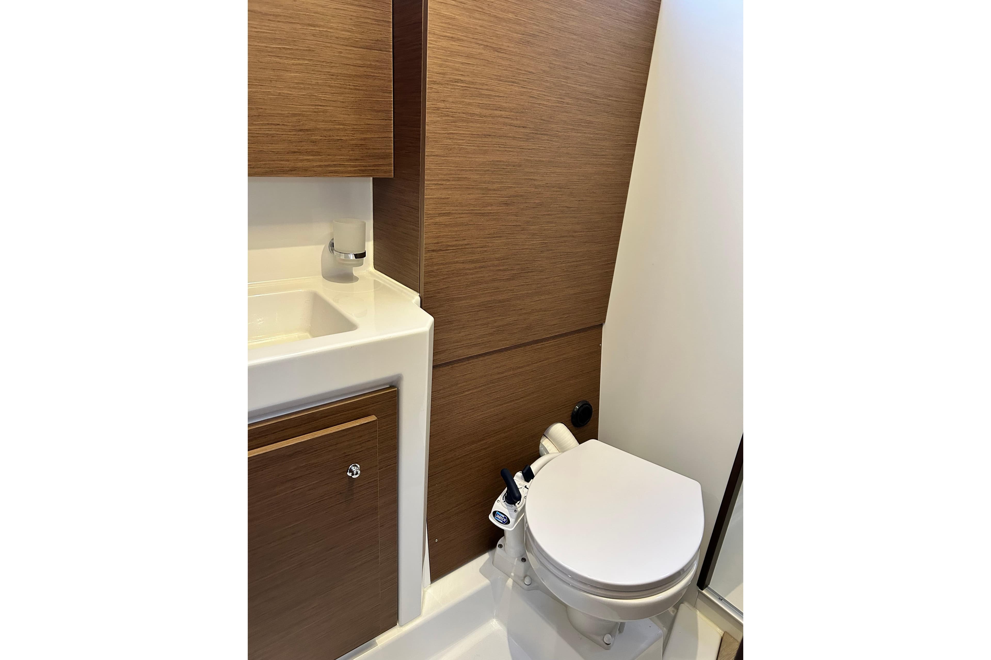 Modern bathroom in 2025 Beneteau Oceanis 37.1 yacht with wood accents and compact design.