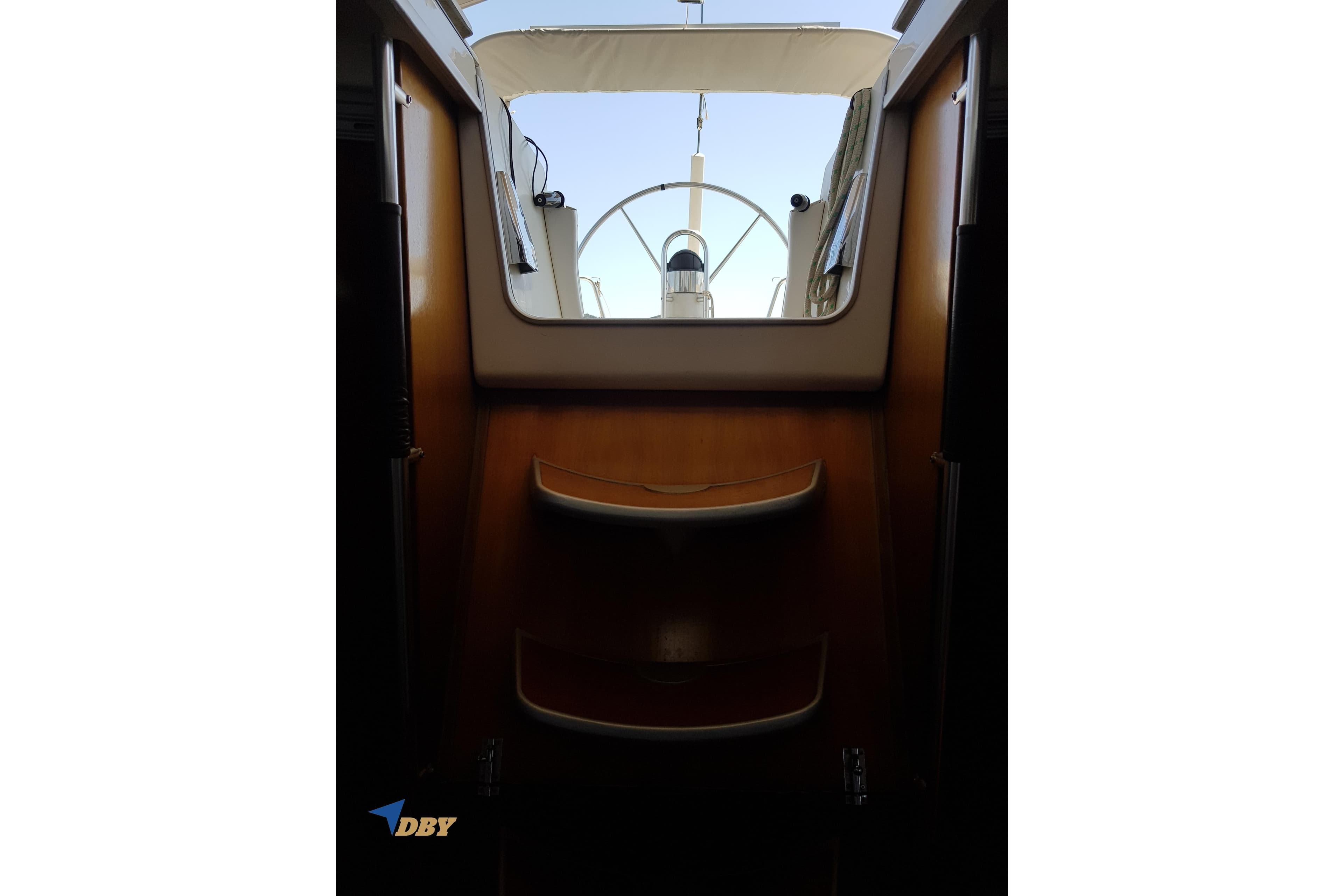 Interior view of 1993 Beneteau First 45f5 yacht, showcasing wooden steps and cockpit entrance.