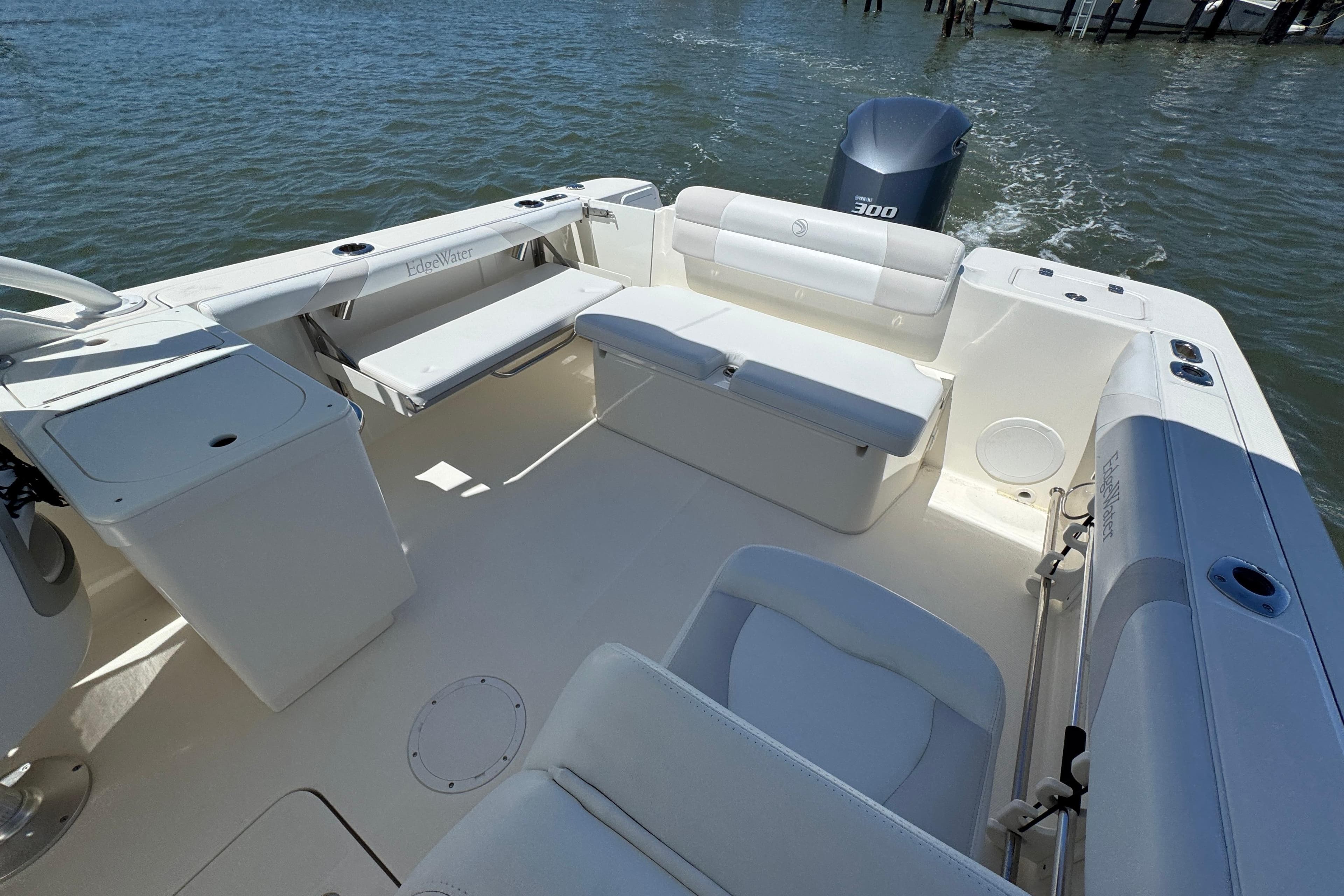 2012 Edgewater 245CX Crossover boat interior with seating and outboard motor on water.