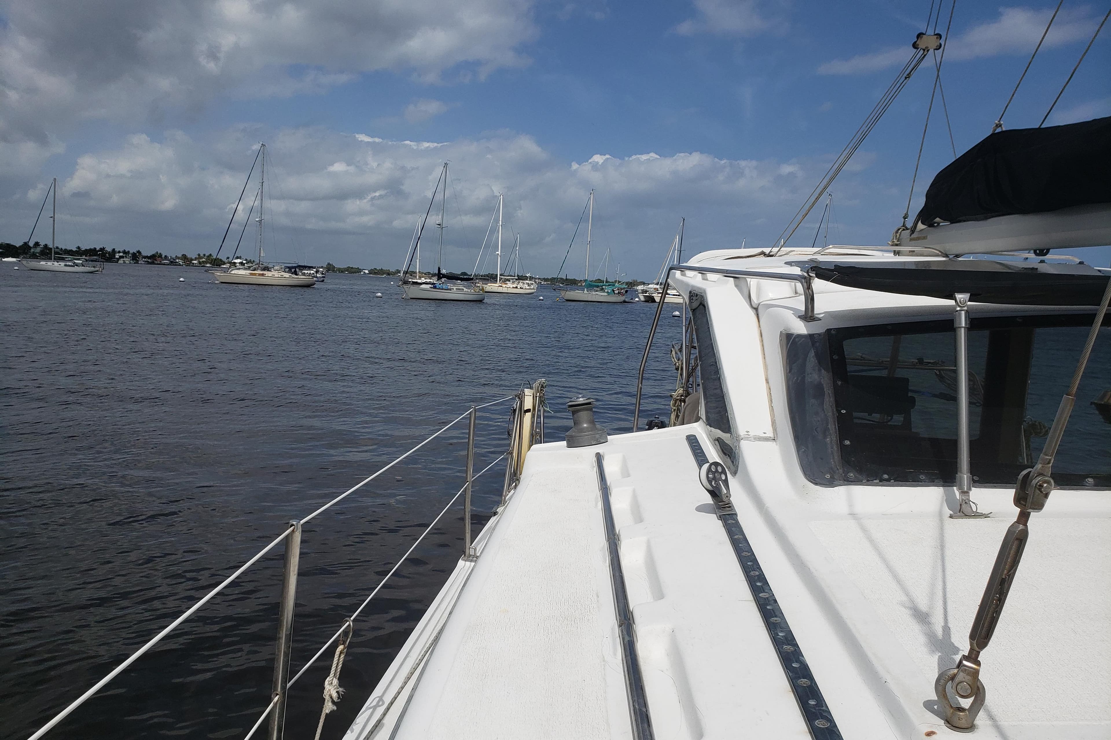 Sailboats on calm water viewed from a 2006 Gemini 105 MC catamaran deck.