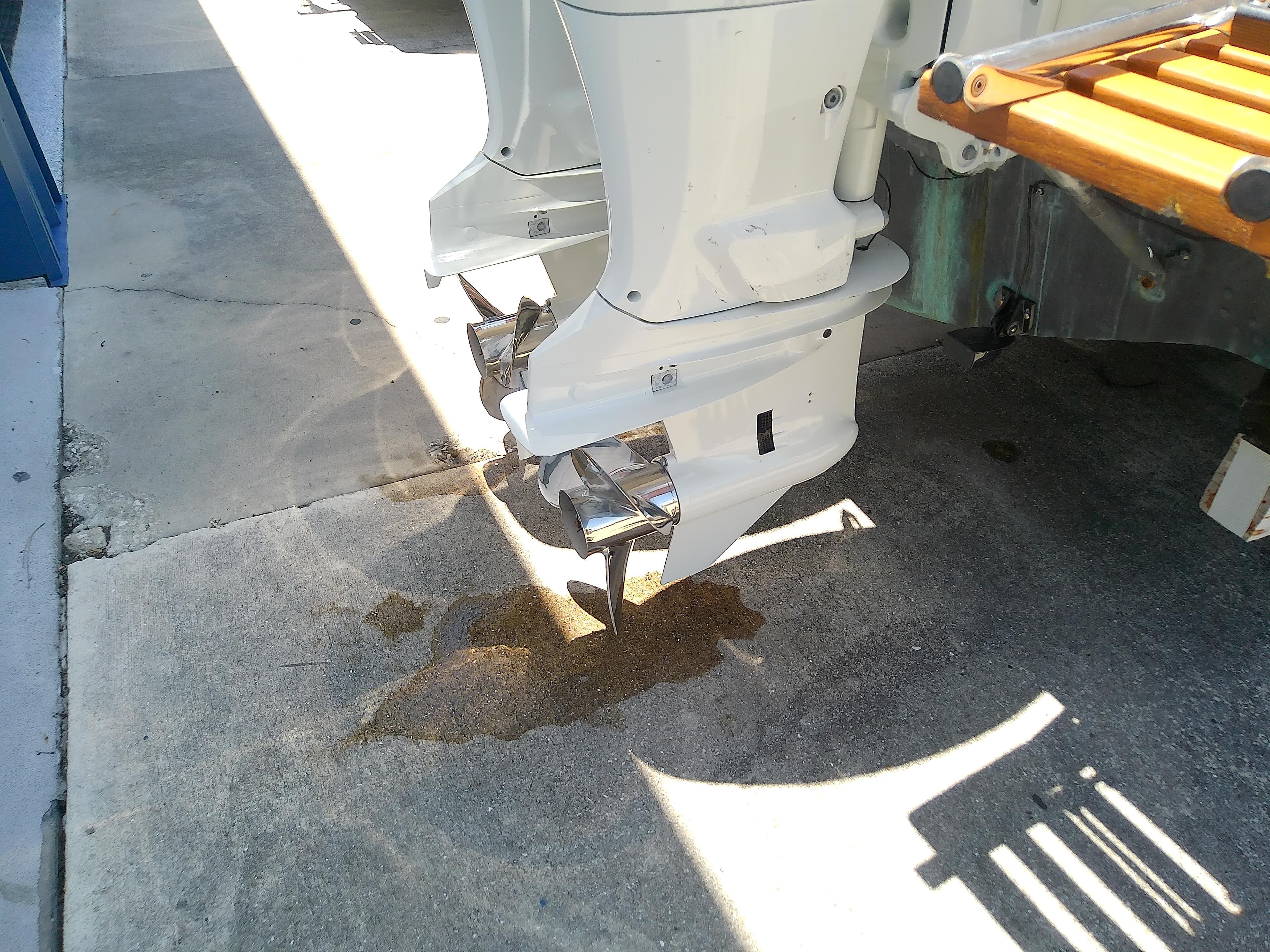 1985 Robalo 2520 Center Console boat with dual outboard motors on concrete surface.