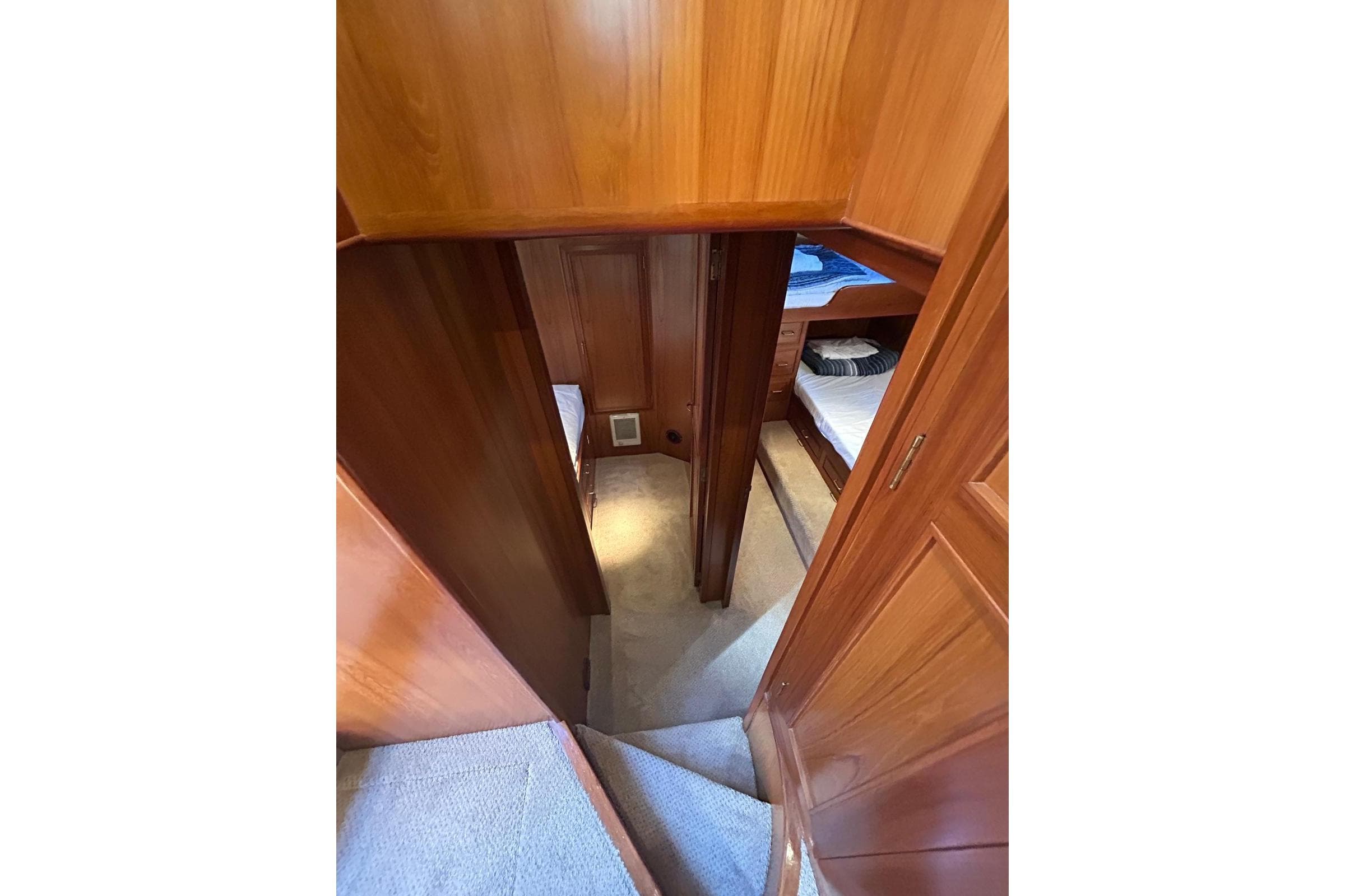 Interior view of 1994 Ocean Alexander 520 Pilothouse with wooden paneling and carpeted stairs.