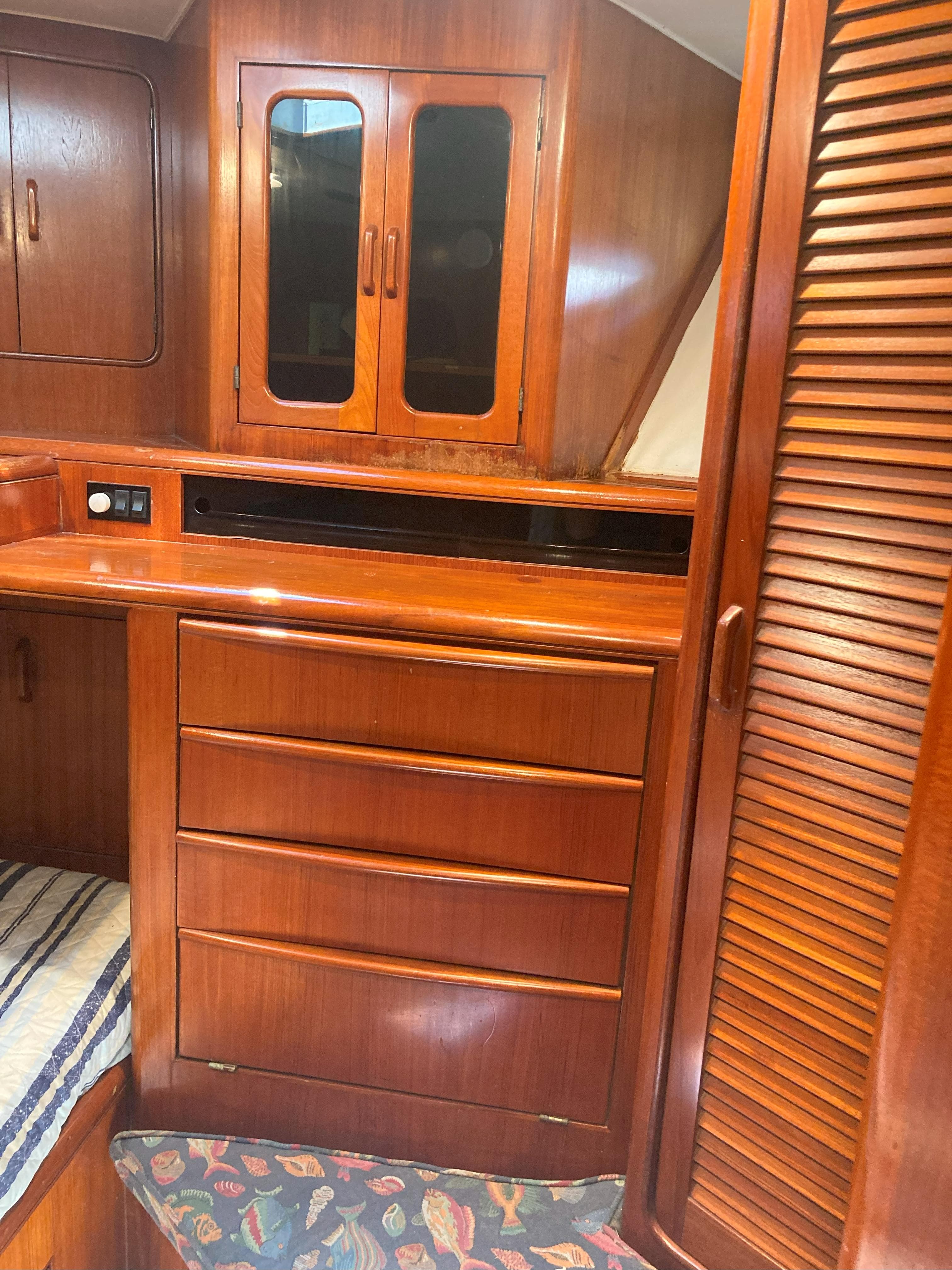 Interior cabin of a 1988 Viking 70 Cockpit Motor Yacht with wooden cabinetry.