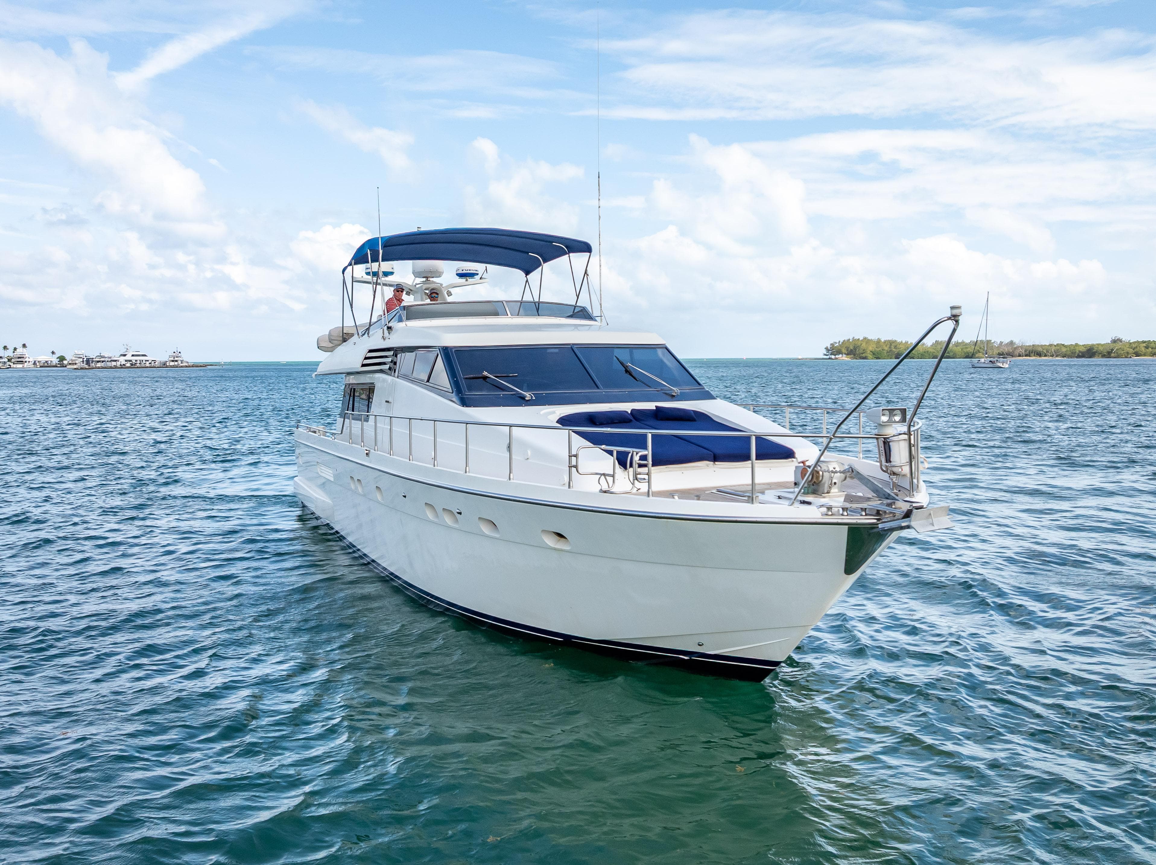 Sanlorenzo 62 yacht from 1995 cruising on a sunny day in open waters.