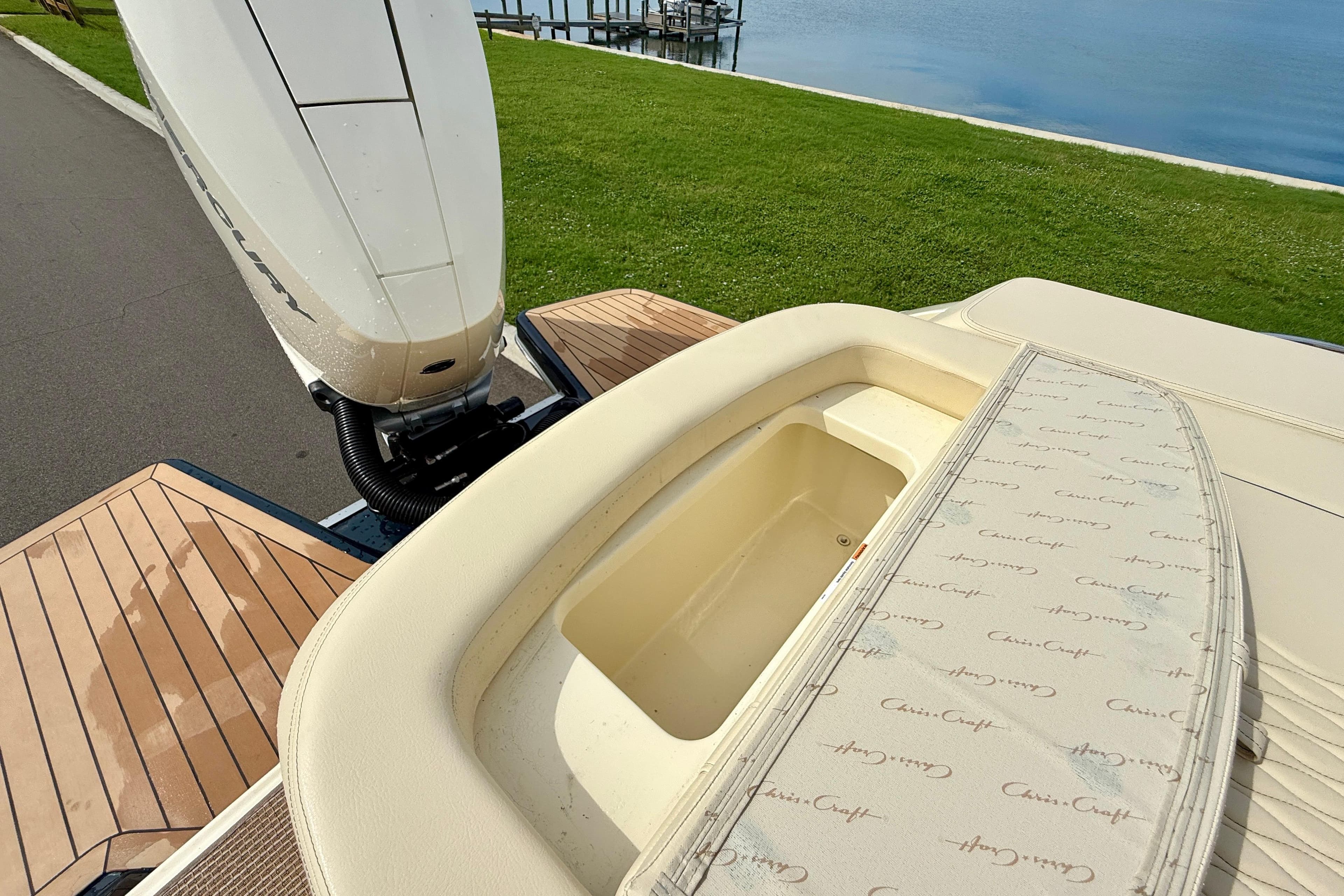 2026 Chris-Craft Sportster 28 boat with Mercury engine, featuring elegant deck and storage area.