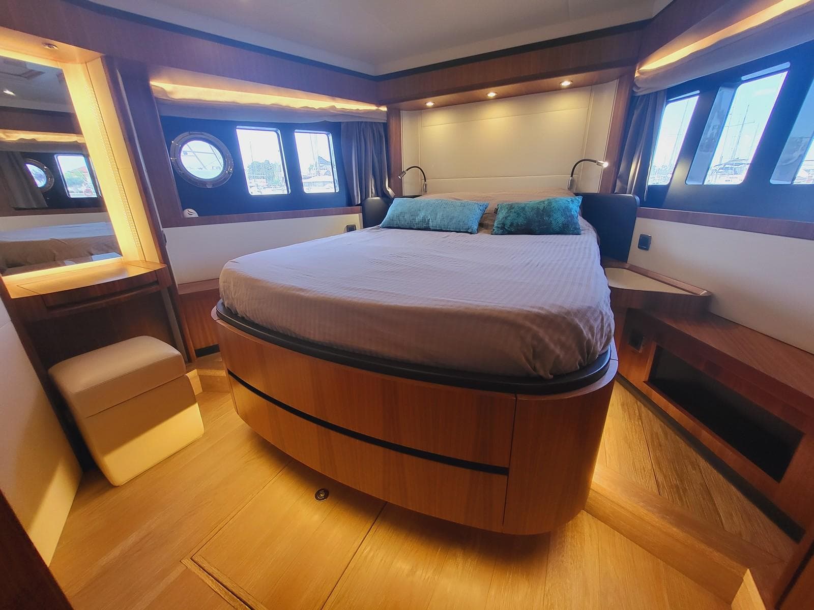 Luxurious bedroom interior of 2017 Absolute NAVETTA 58 yacht with elegant wood finishes.