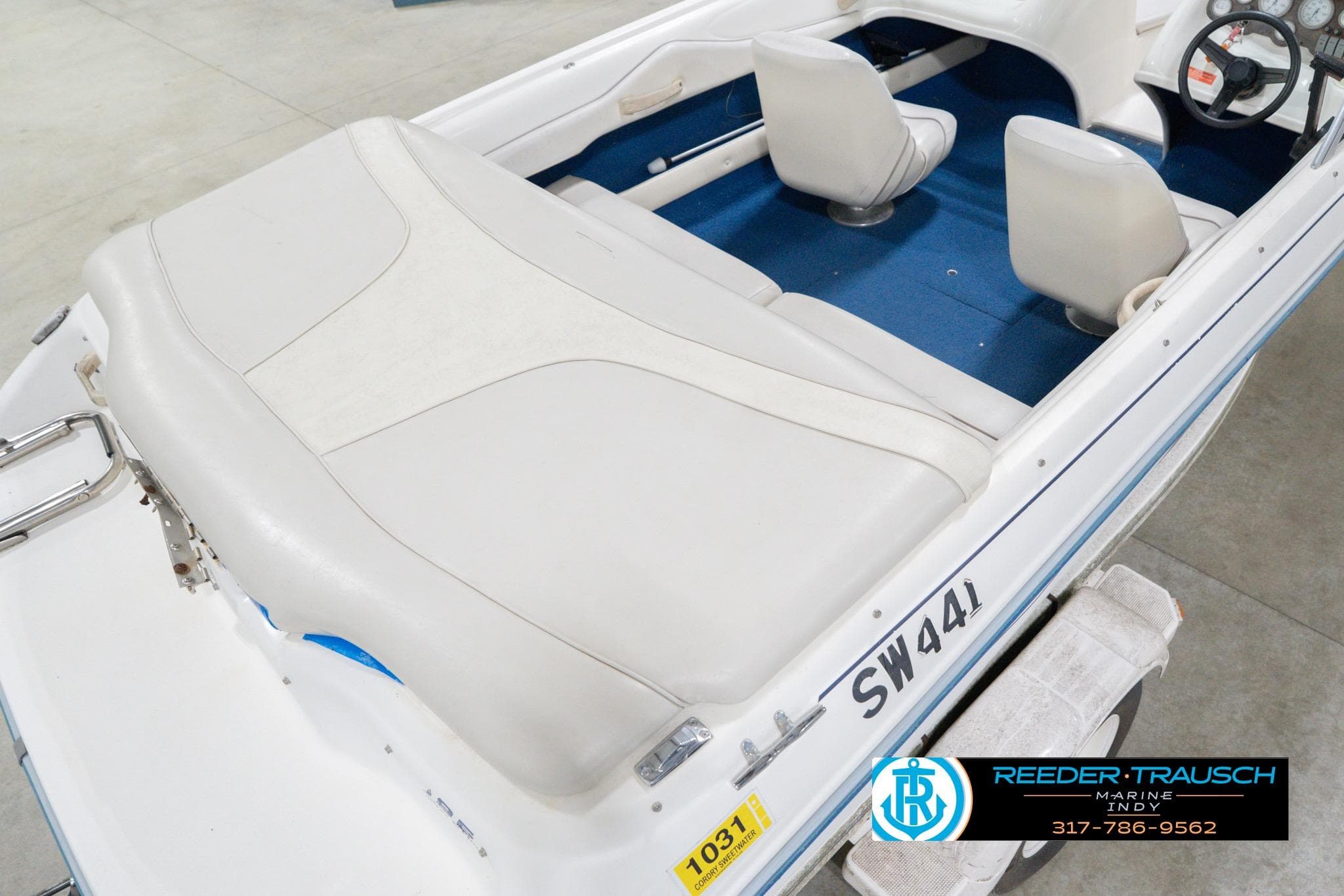 1995 Sea Ray 175 Bow Rider boat interior with white seating and blue carpet.