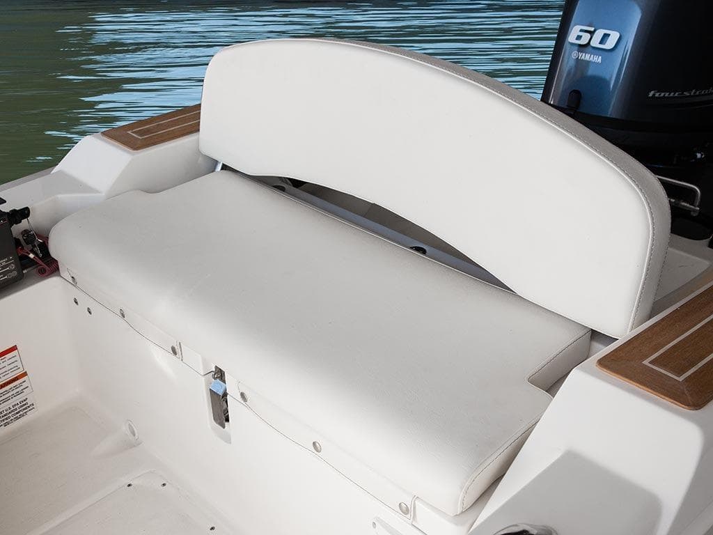 White seating area on 2014 Capelli 460 boat with Yamaha engine in background.