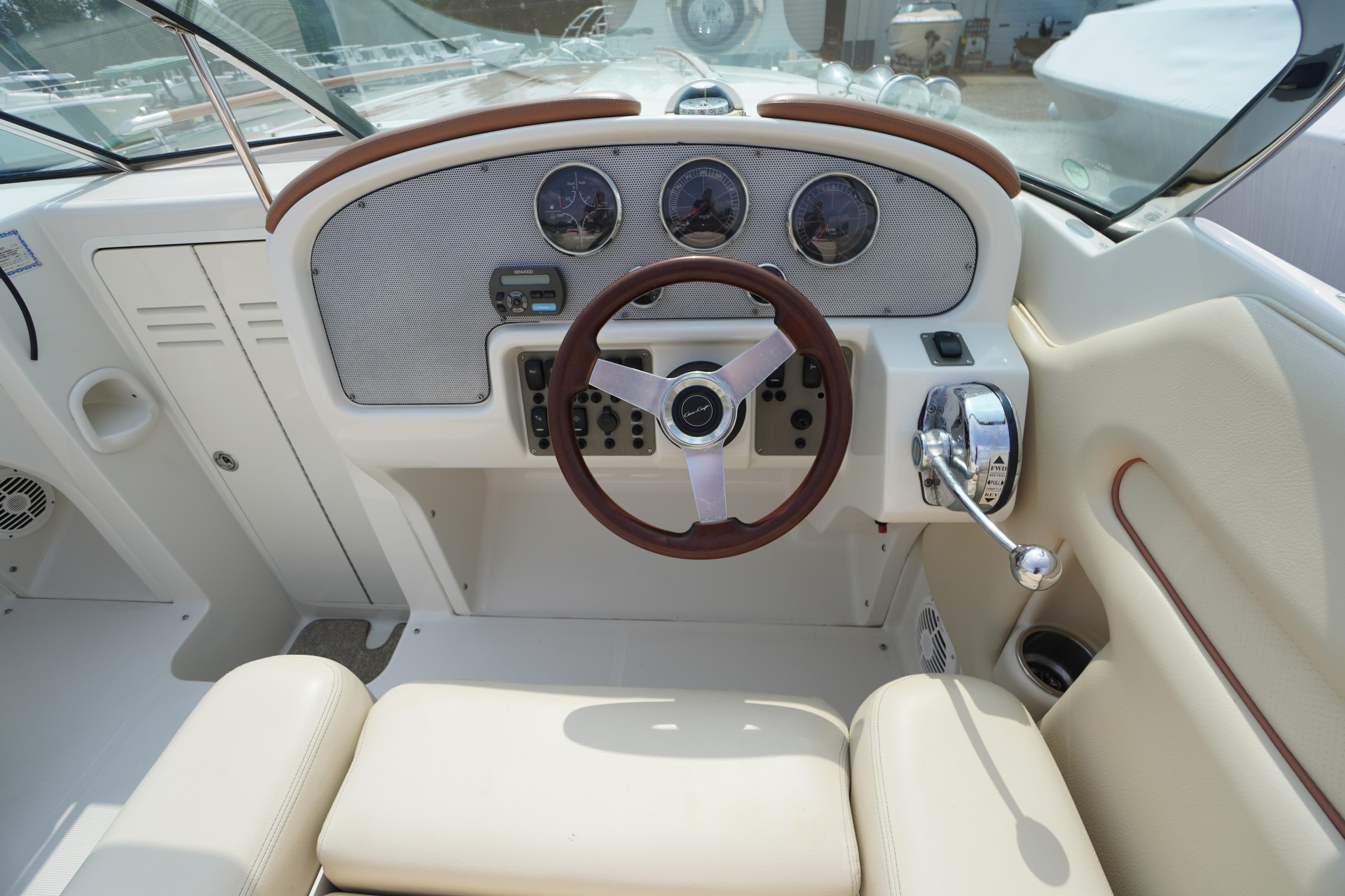 2007 Chris-Craft Corsair 28 boat dashboard with steering wheel and controls.