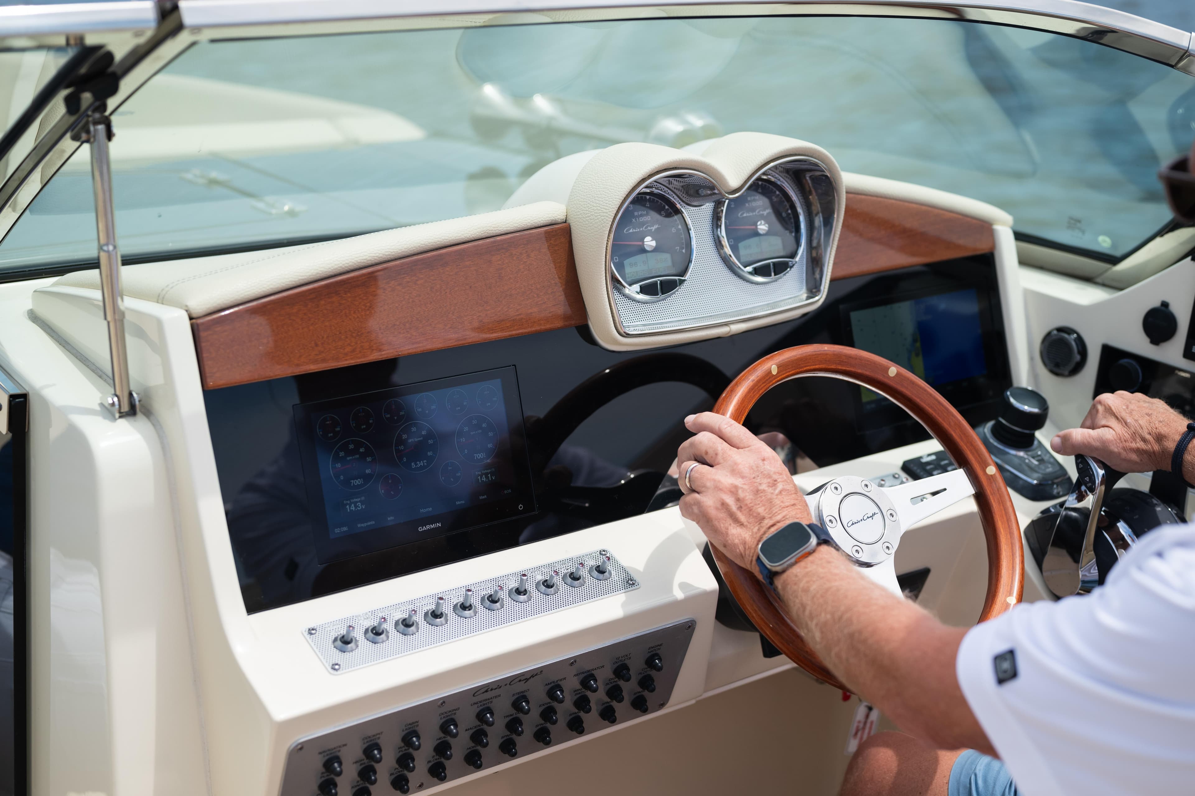 2022 Chris Craft 34 Launch Heritage dashboard with wooden steering wheel and modern controls.