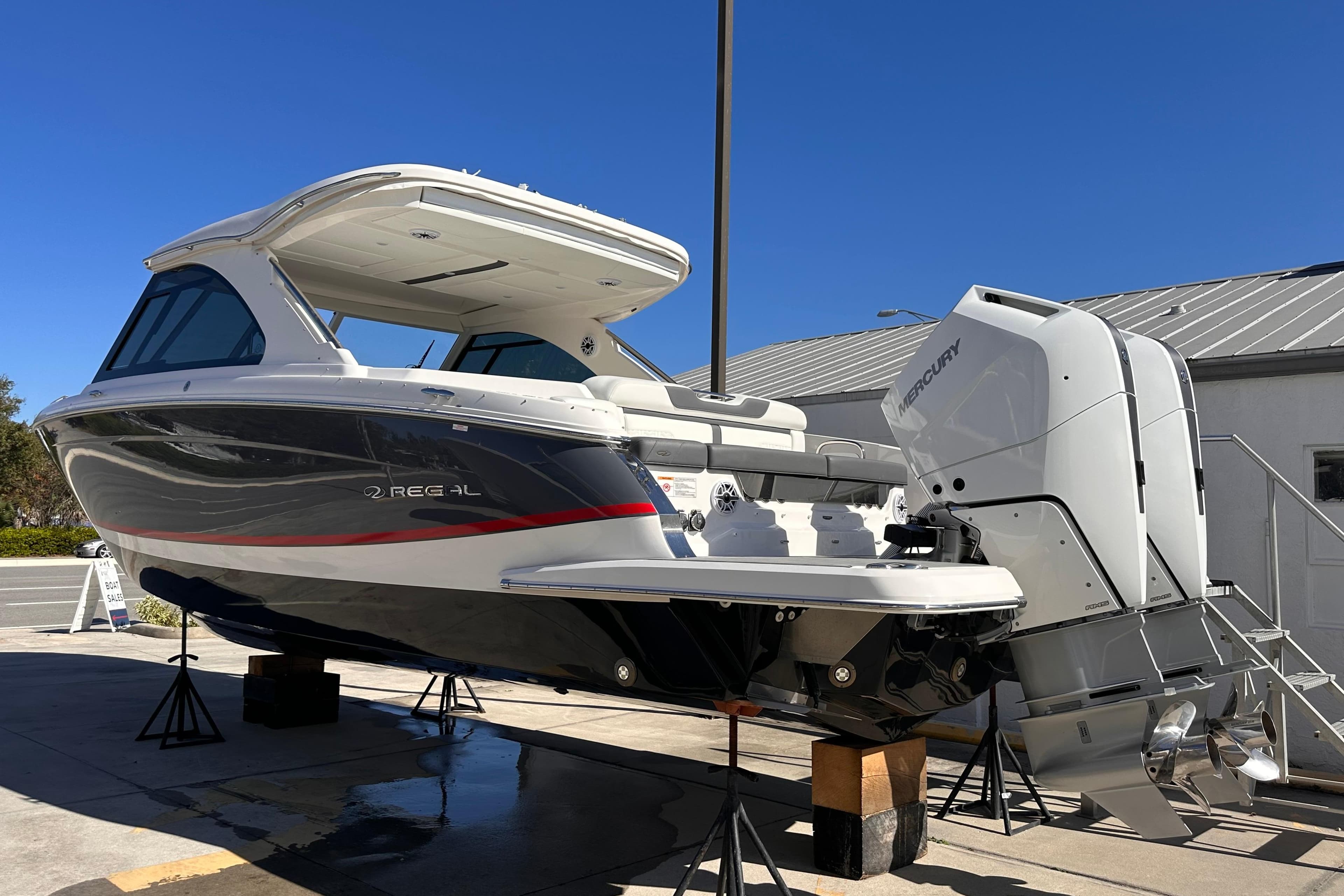 2025 Regal LX36 boat with dual Mercury engines displayed outdoors.