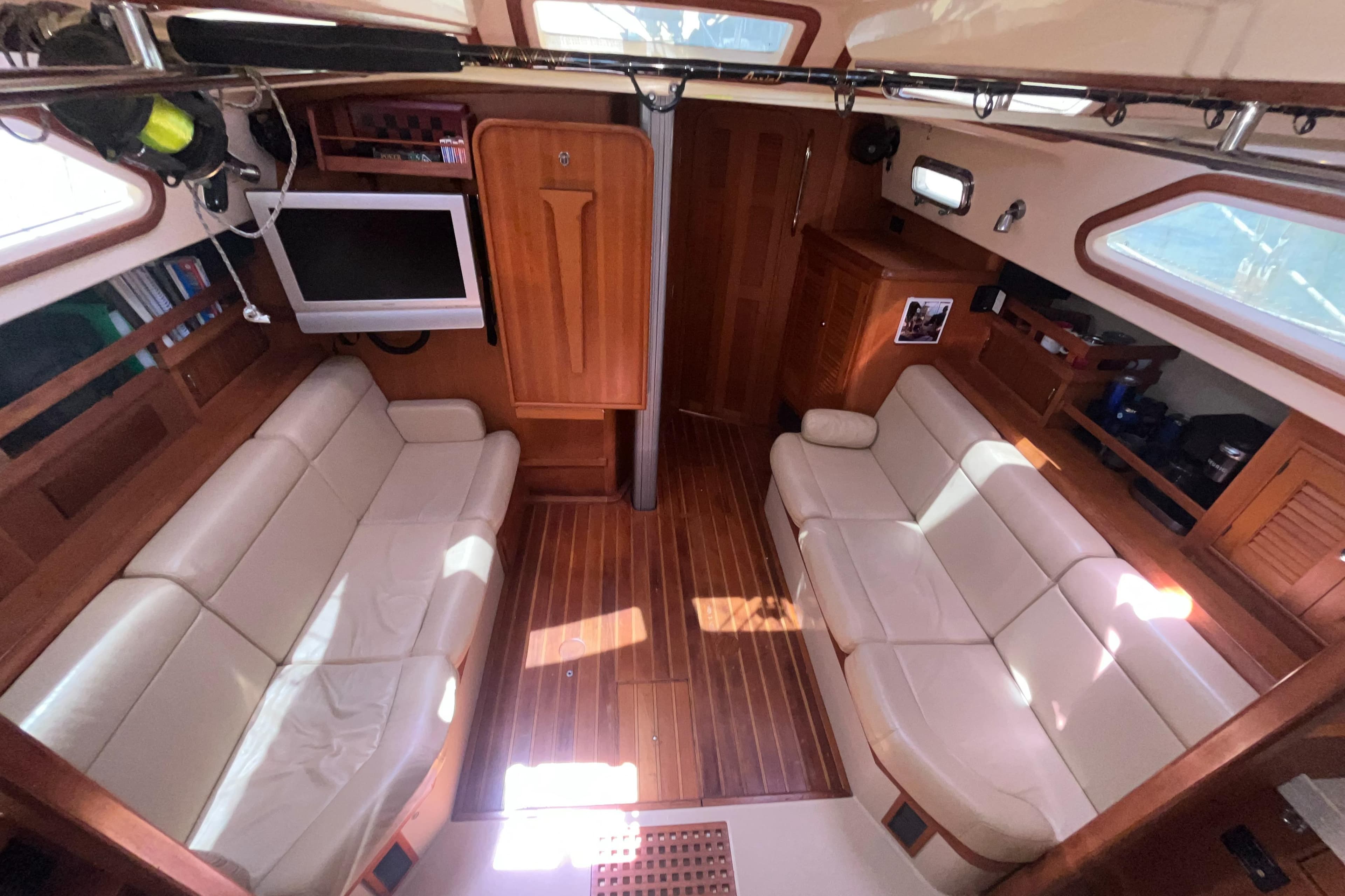 Luxurious interior of 2006 Island Packet 445 yacht with leather seating and wood finish.