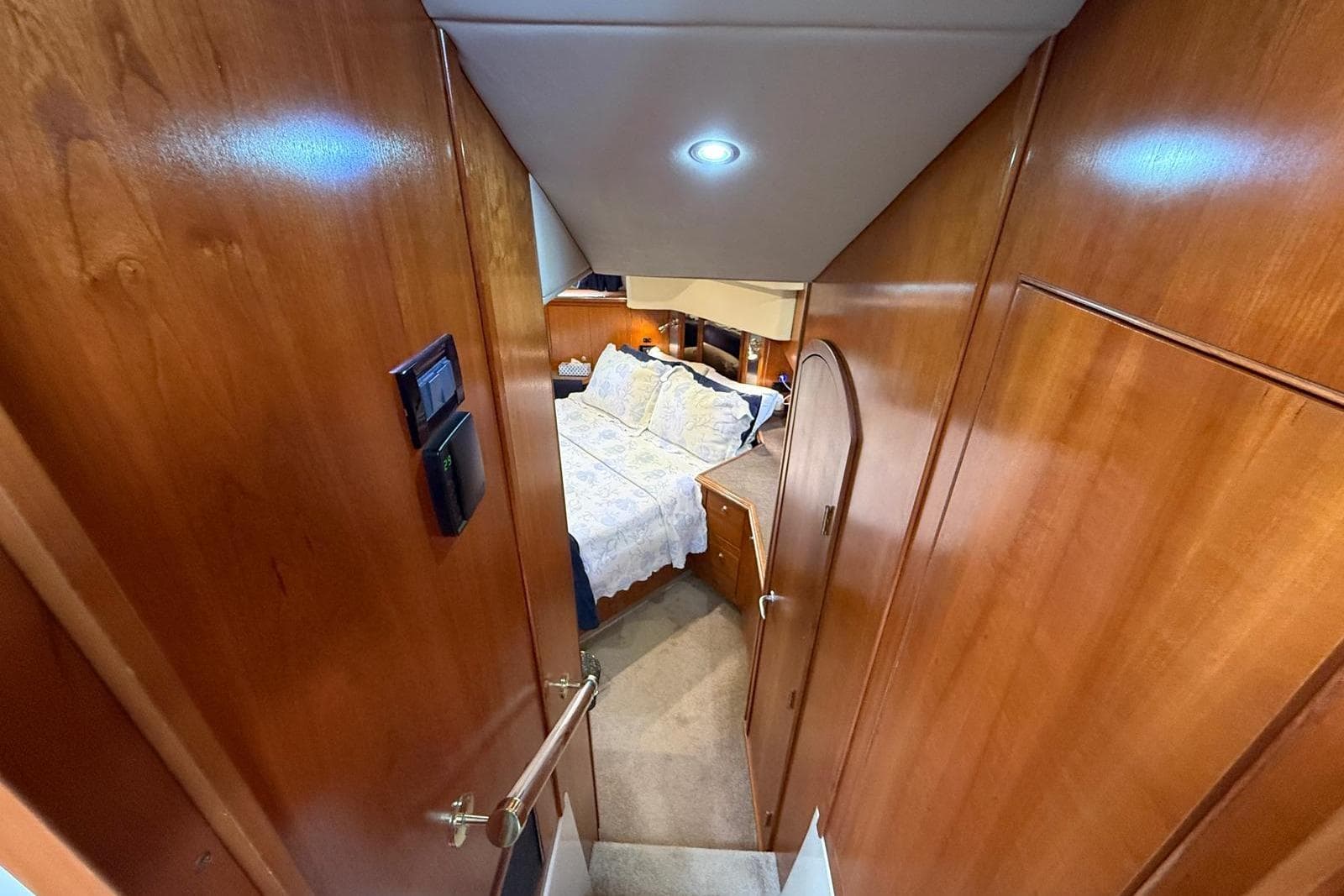 Luxurious cabin interior of 2005 Cruisers Yachts 455 Express Motoryacht with wood paneling.