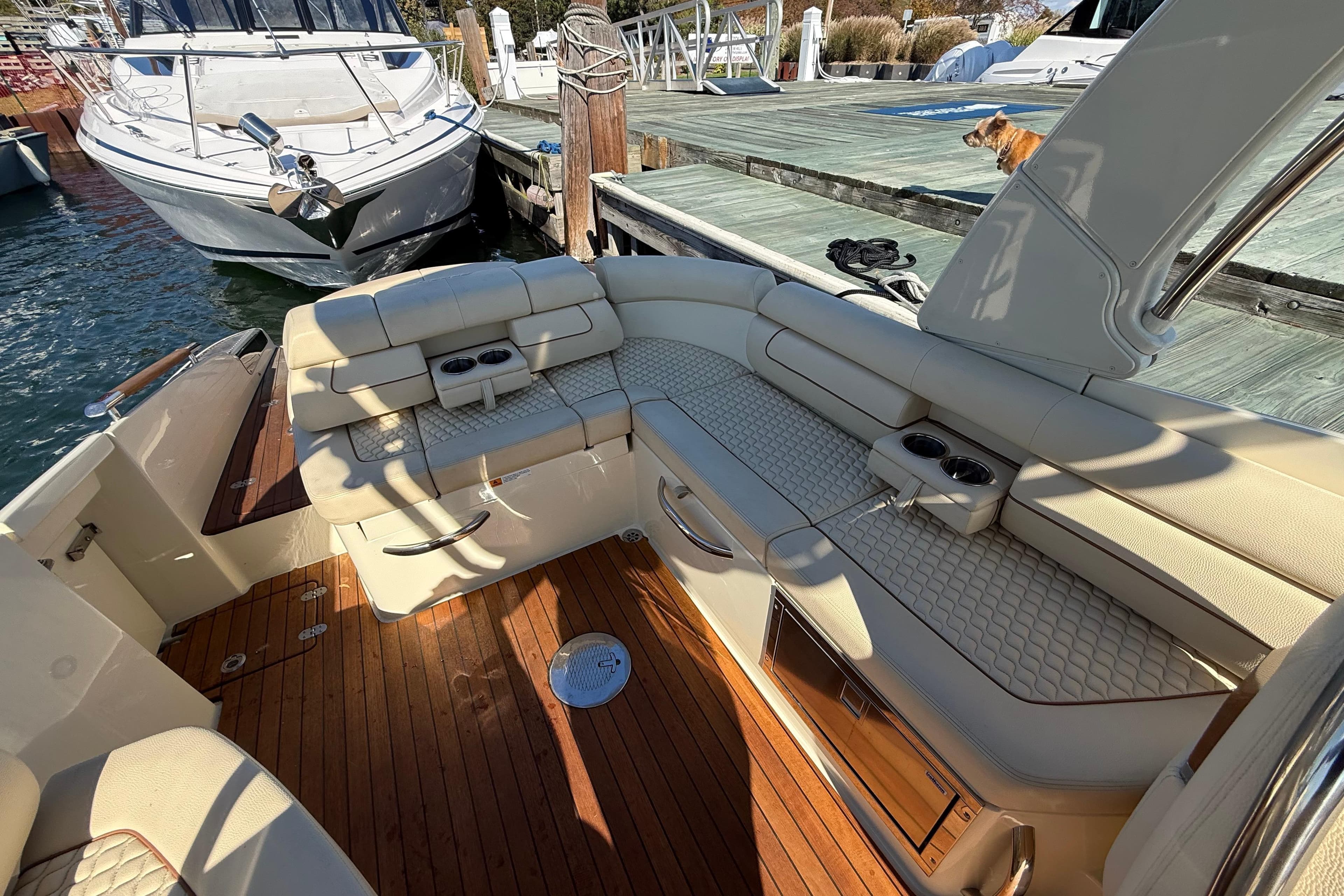 2019 Chris-Craft Launch 28 GT boat interior with luxurious seating and wooden deck.