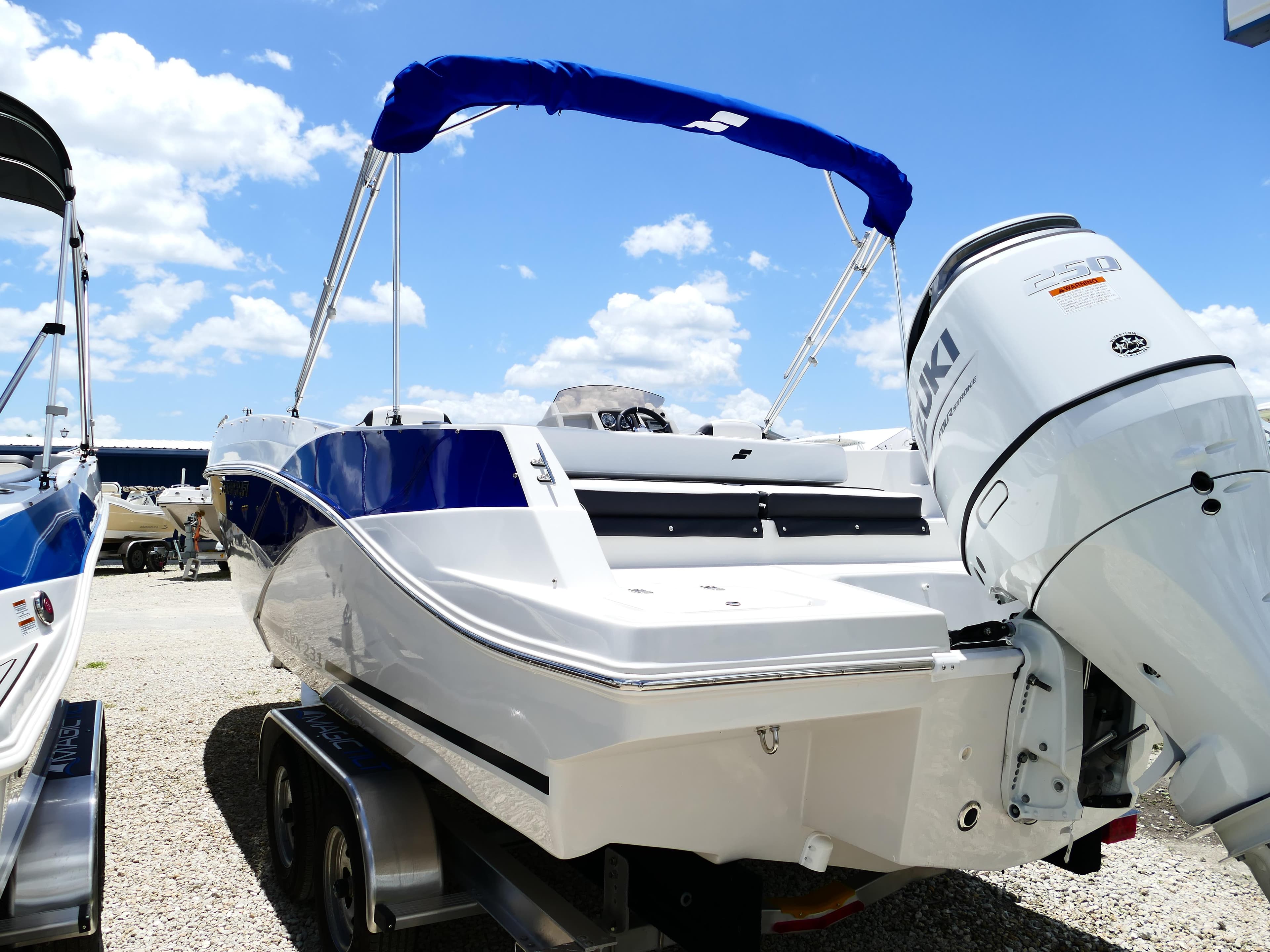 2026 Starcraft SVX 231 OB DH boat with Suzuki outboard motor, parked on a trailer.