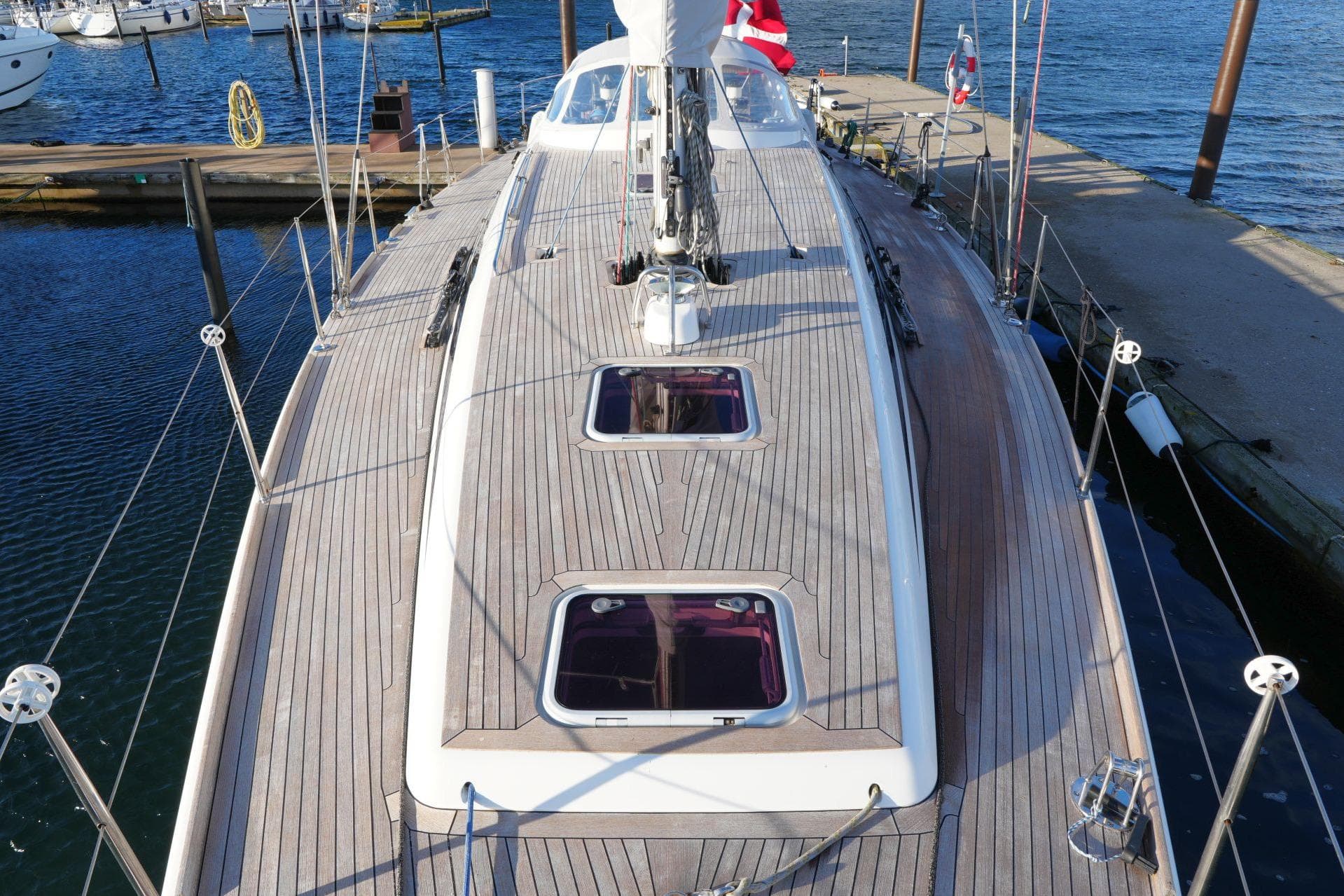 Sailboat deck of 2005 Nautor Swan 46 MK III docked at marina.