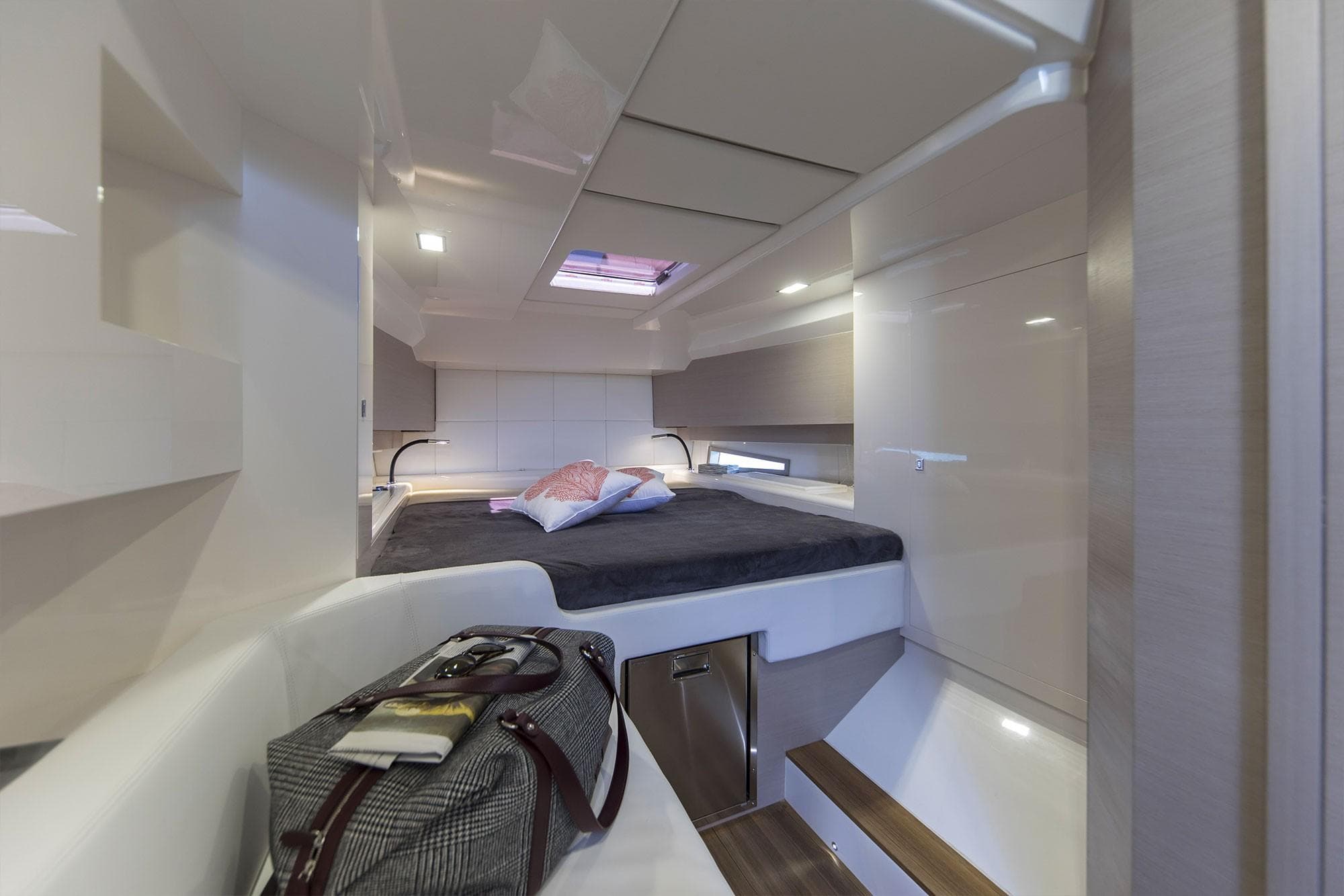 Interior cabin of 2022 SACS Rebel 47 yacht with bed and luggage.