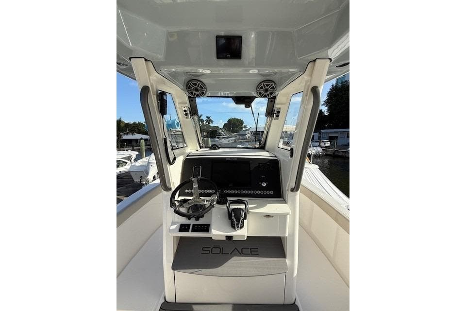 2025 Solace 28HCS boat helm with modern controls and steering wheel.