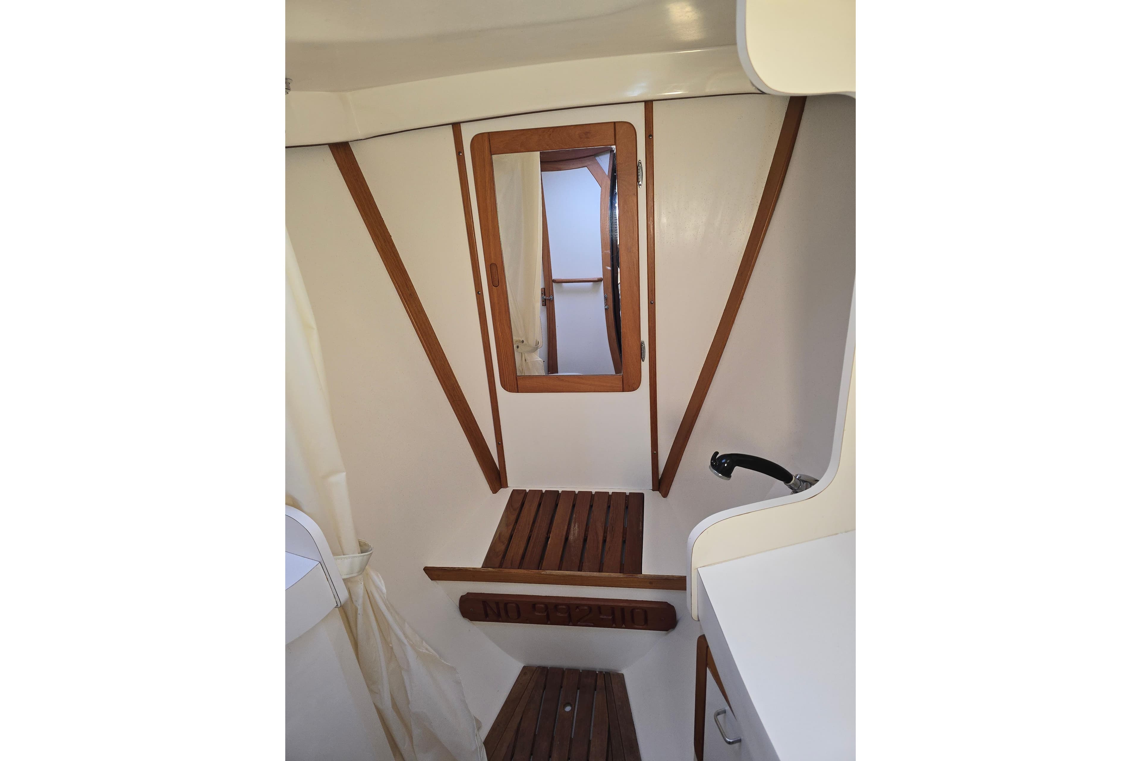Interior of 1993 Catalina 42 sailboat with wooden accents and mirror.
