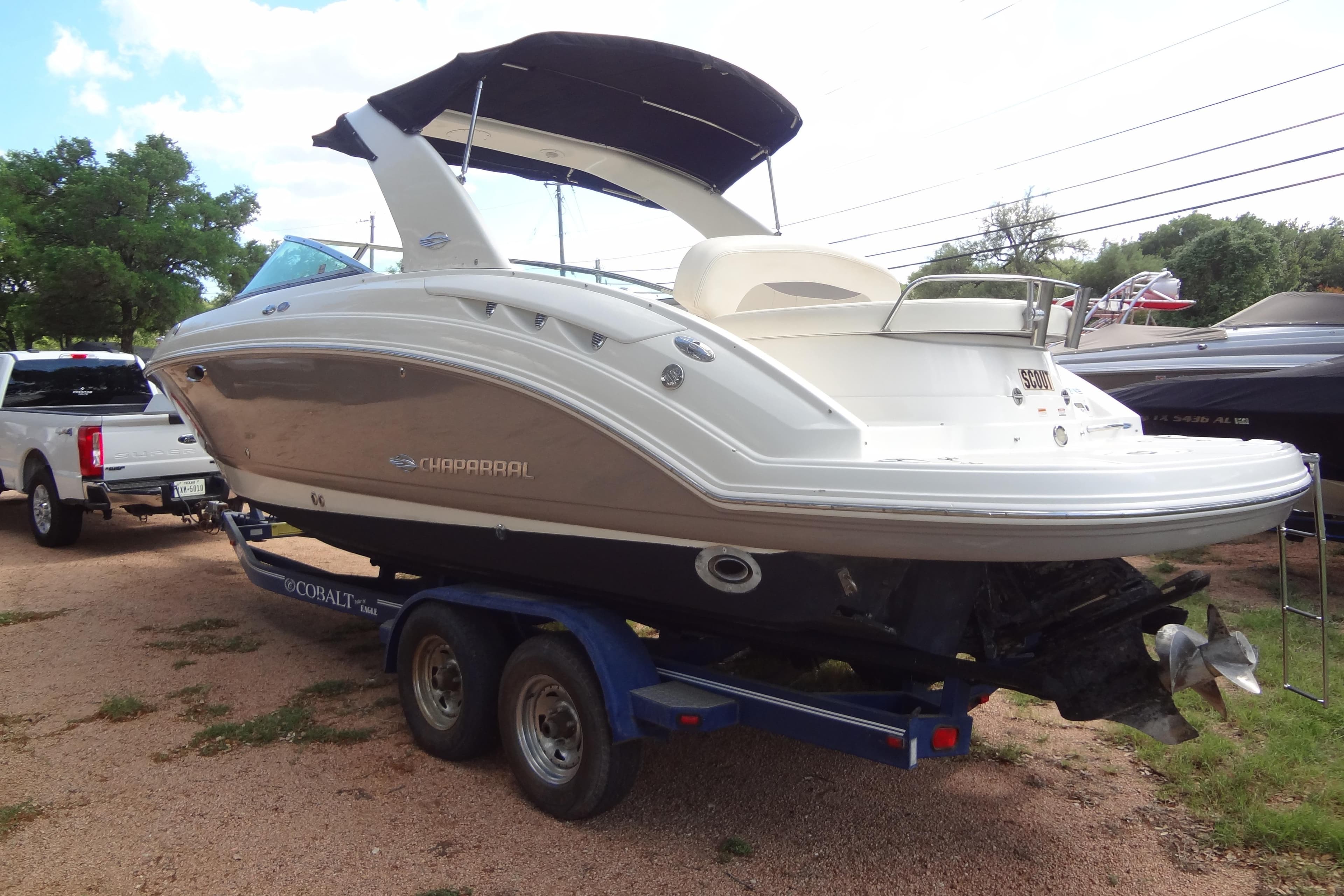2008 Chaparral 276 SSX boat on trailer, parked outdoors.