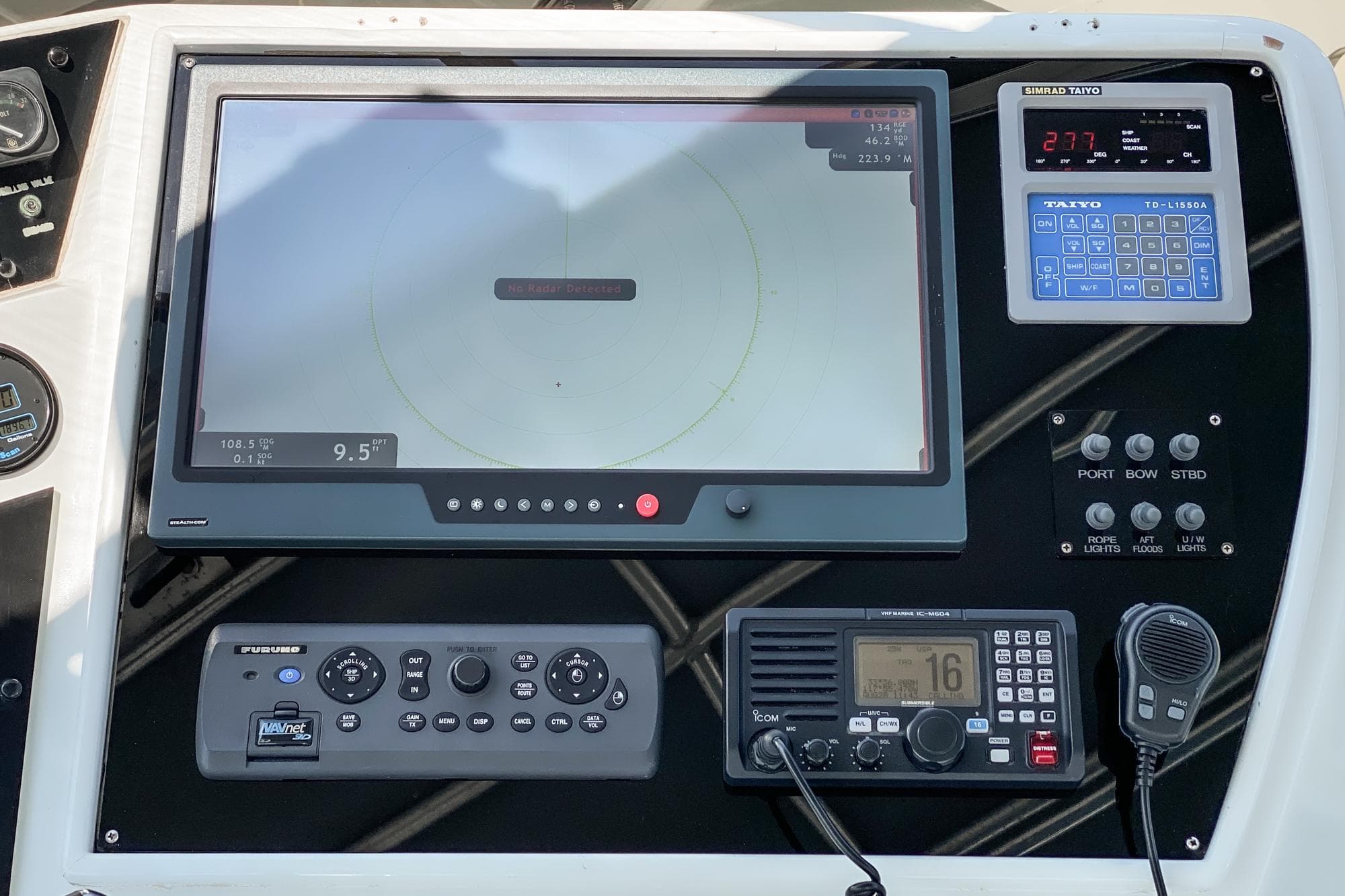 Control panel of a 1990 Hatteras 58 Sportfish with navigation and communication equipment.