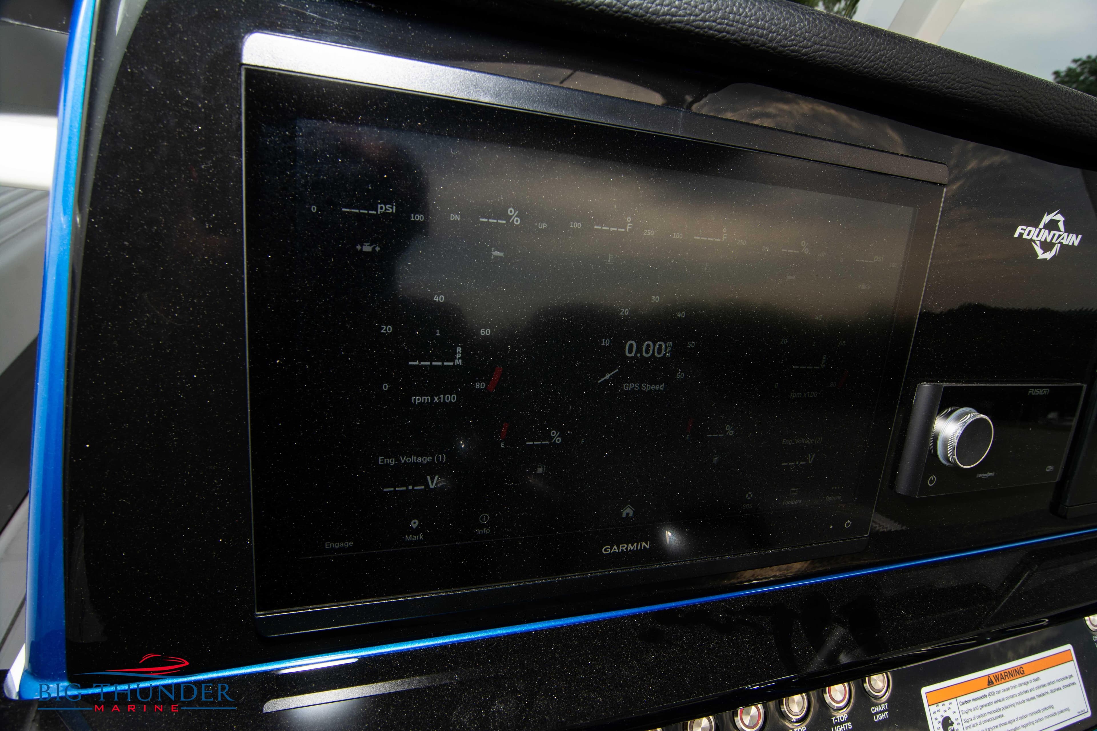 2023 Fountain 34 CC boat dashboard with Garmin display and controls.