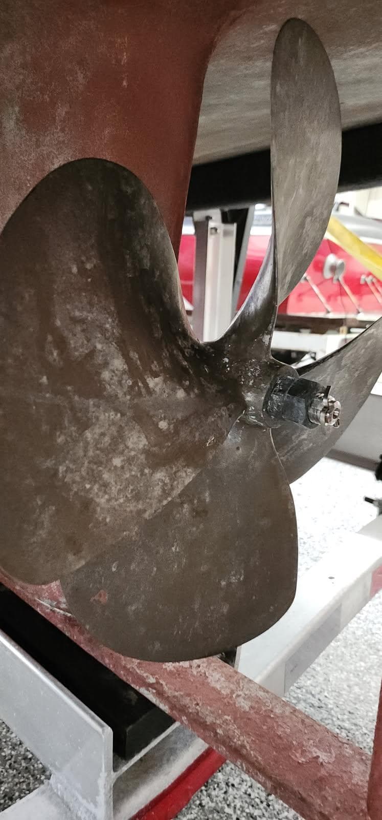 Propeller of 1981 Nordic Tug 26, close-up view in dry dock setting.