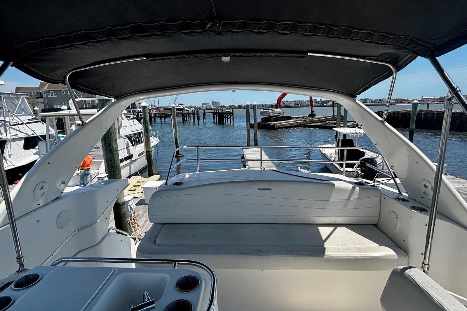2001 Silverton 330 Sport Bridge yacht docked at marina, featuring spacious seating and water view.