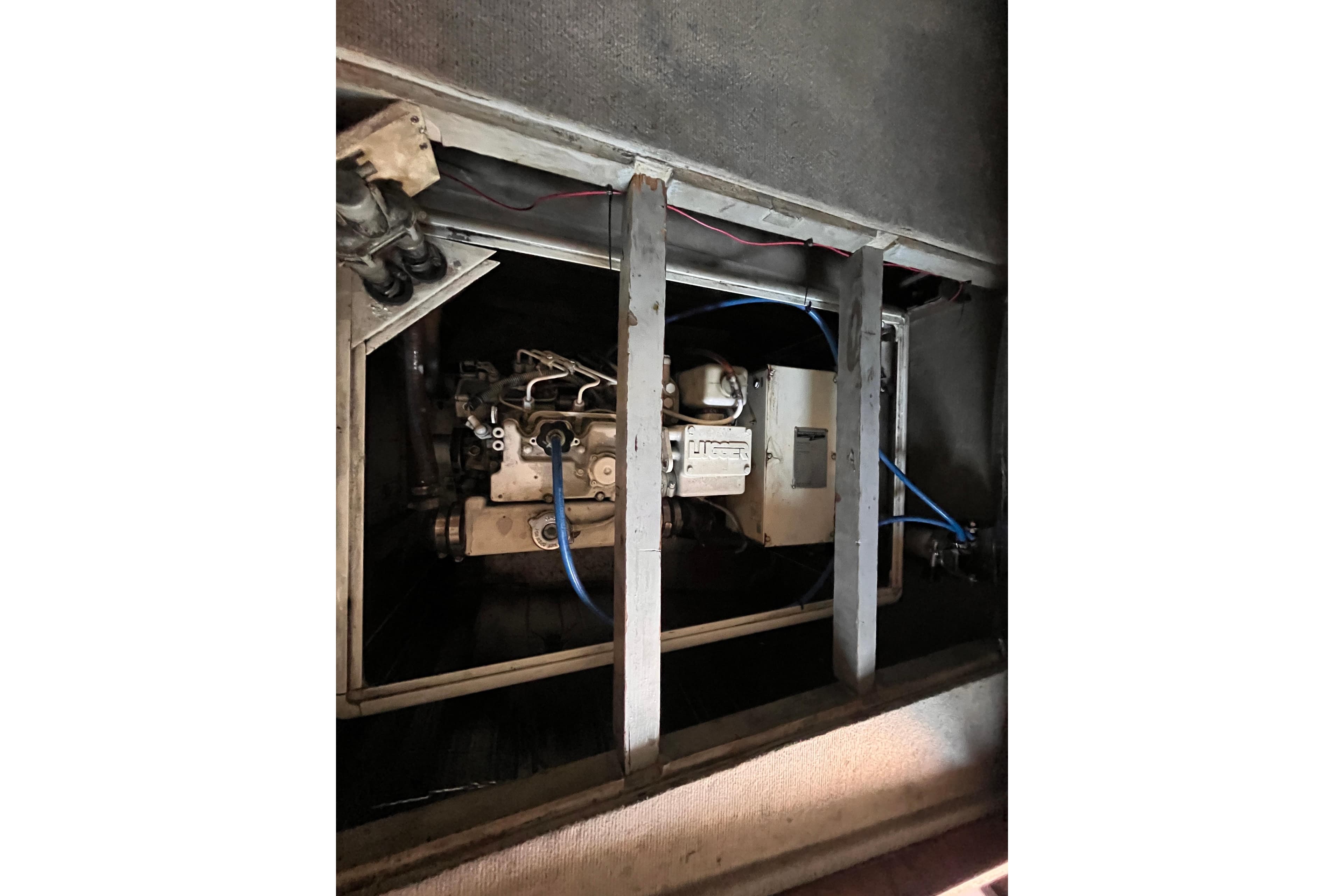 Engine compartment of a 2008 Broadblue 415 catamaran, showcasing mechanical components and wiring.