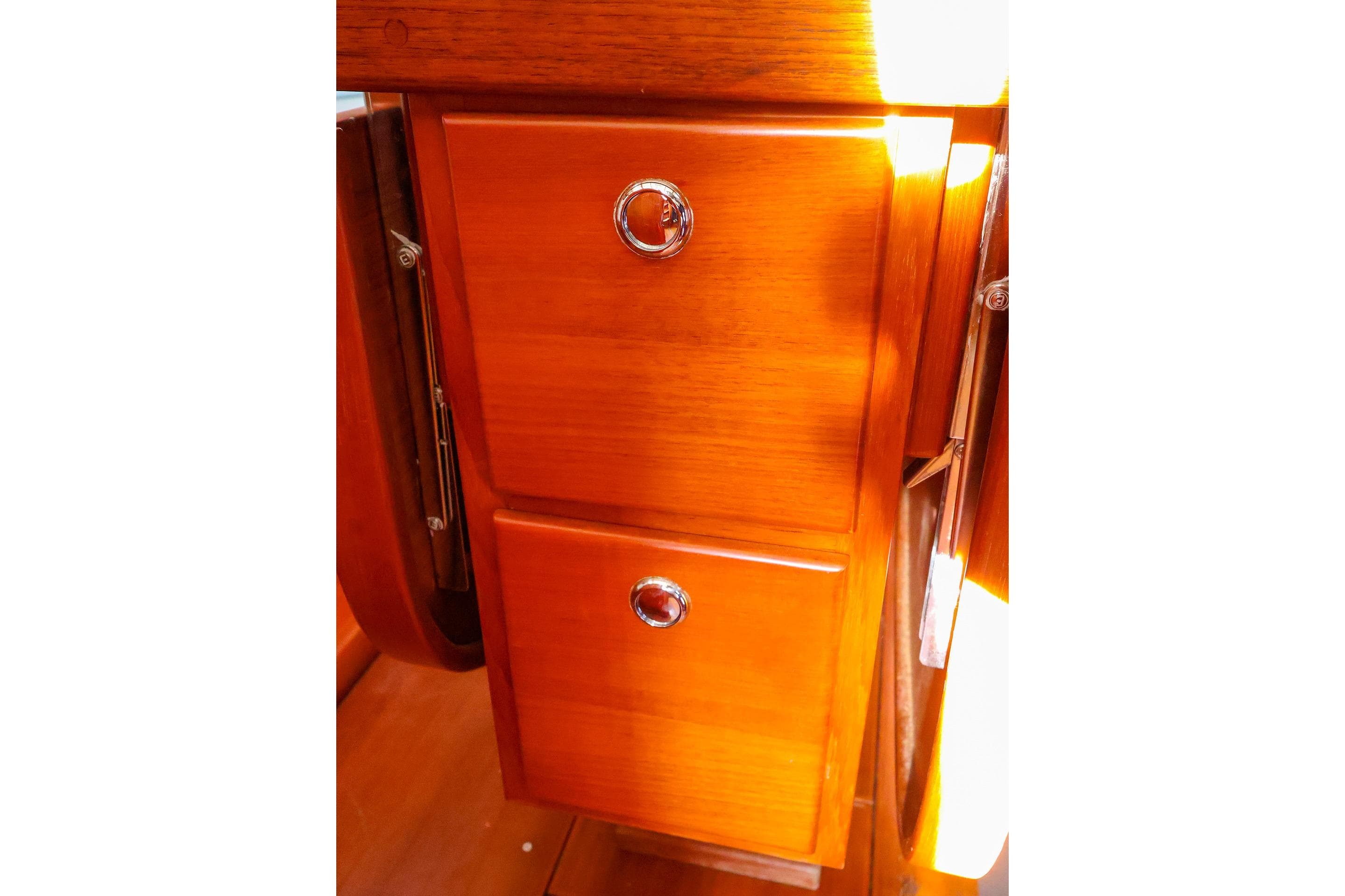 Wooden cabinetry with chrome handles inside a 2004 J Boats J/46 sailboat.
