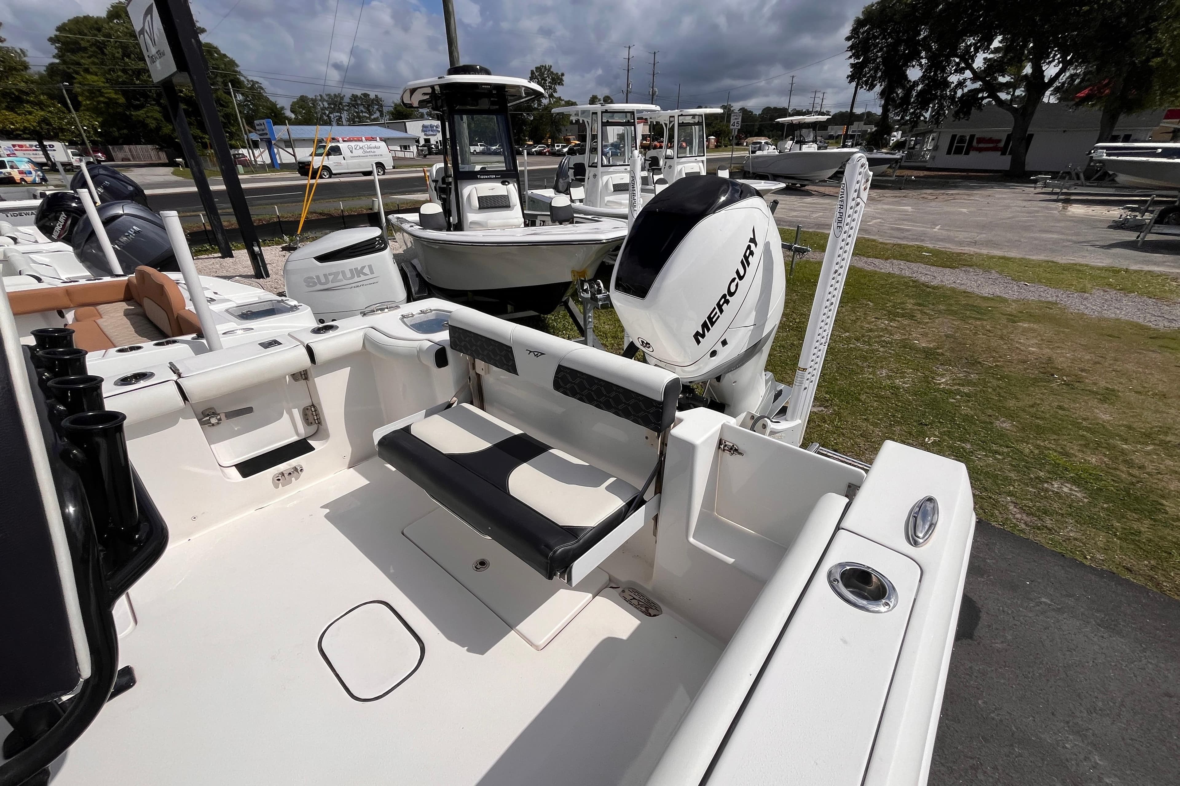 2022 Tidewater 256 CC Adventure boat with Mercury engine, displayed outdoors.