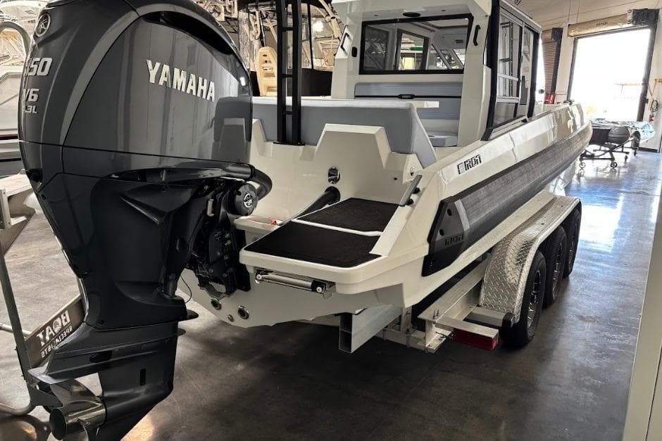 2026 Iron 907 Coupe boat with Yamaha V6 engine on trailer in showroom.