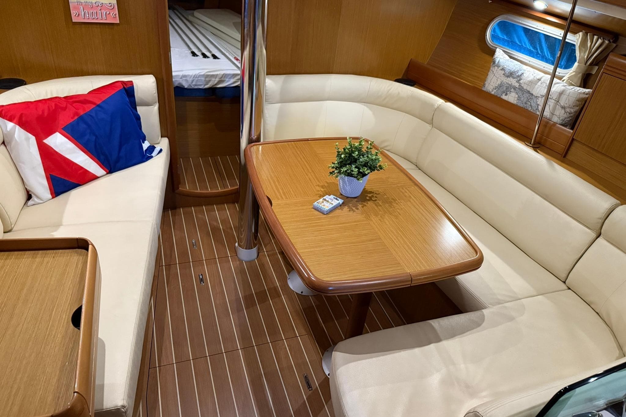 Luxurious interior of 2007 Jeanneau Sun Odyssey 39i sailboat with elegant seating and table.