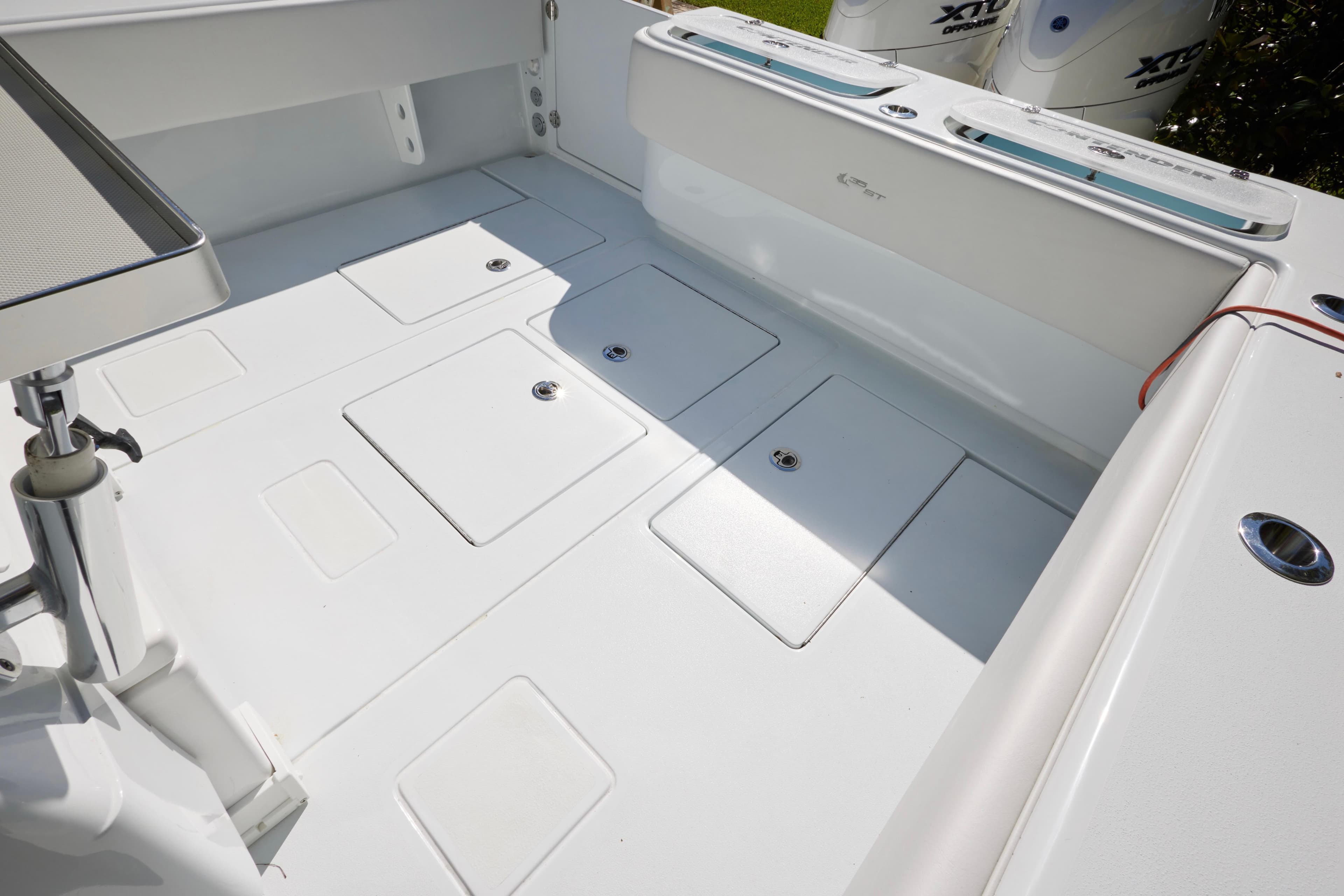 2024 Contender 35 ST boat deck with storage compartments and outboard engines.