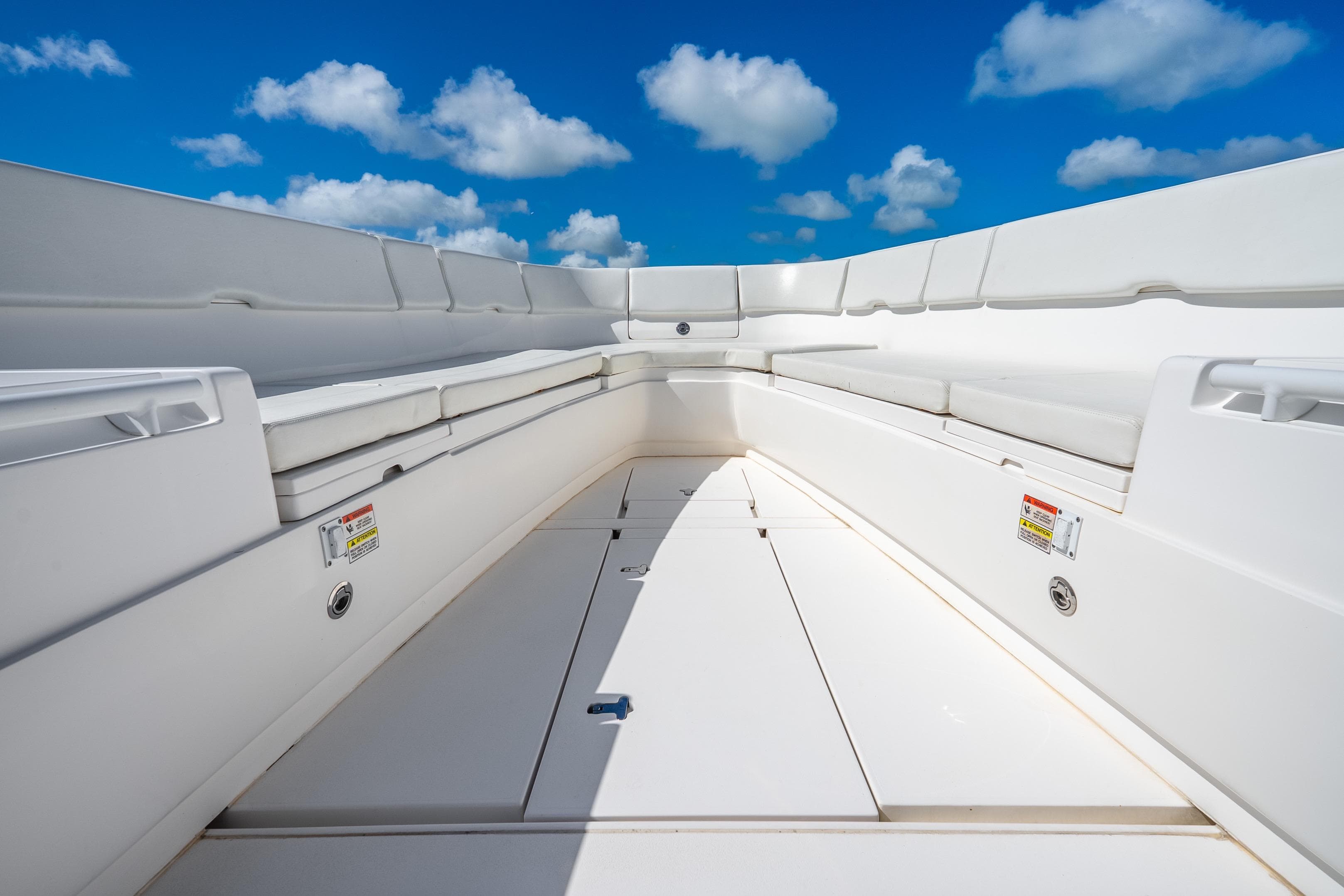 2016 Intrepid 400 Center Console boat interior with white seating under a blue sky.
