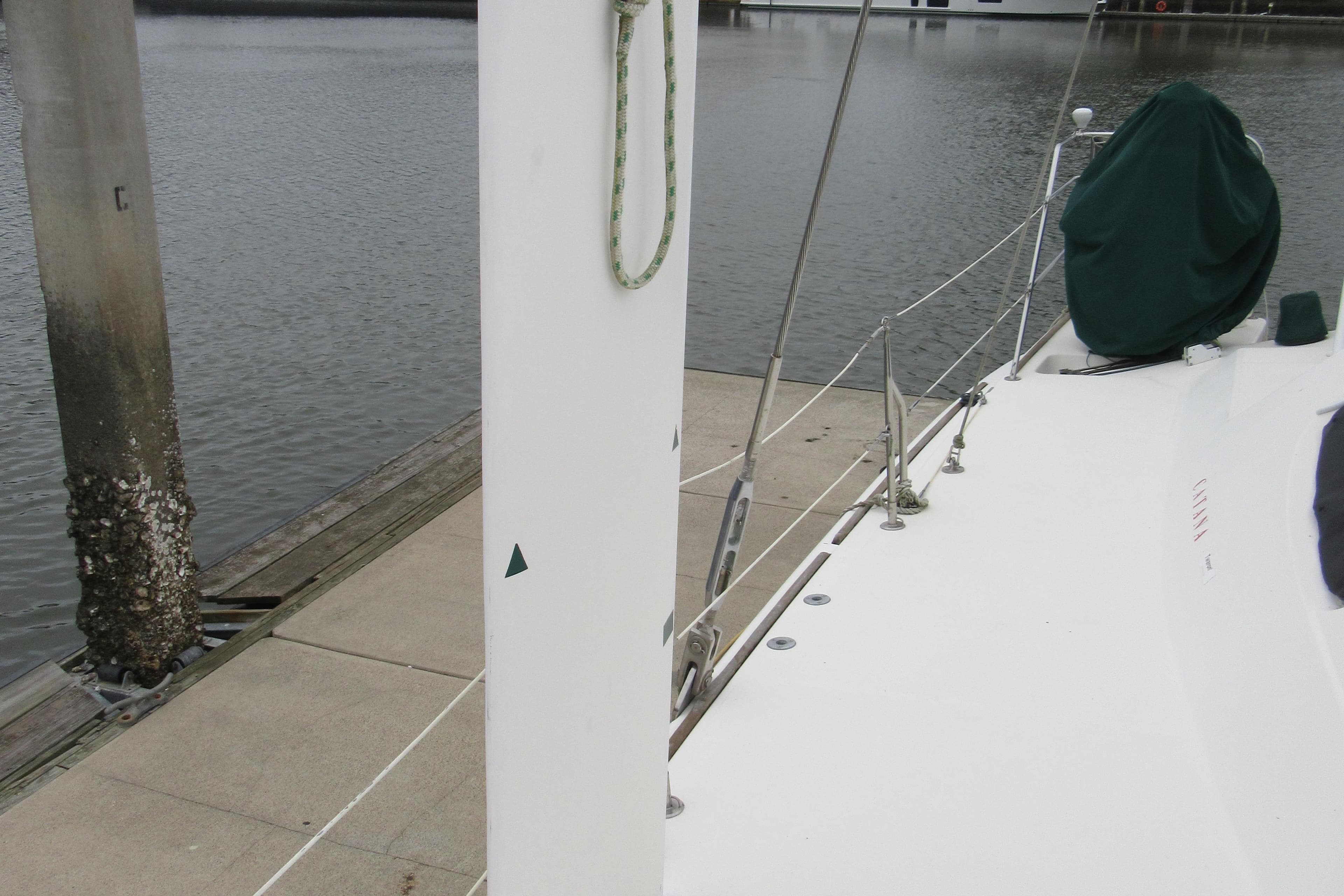 Catana 471 sailboat docked, showcasing deck and mast, 2001 model.