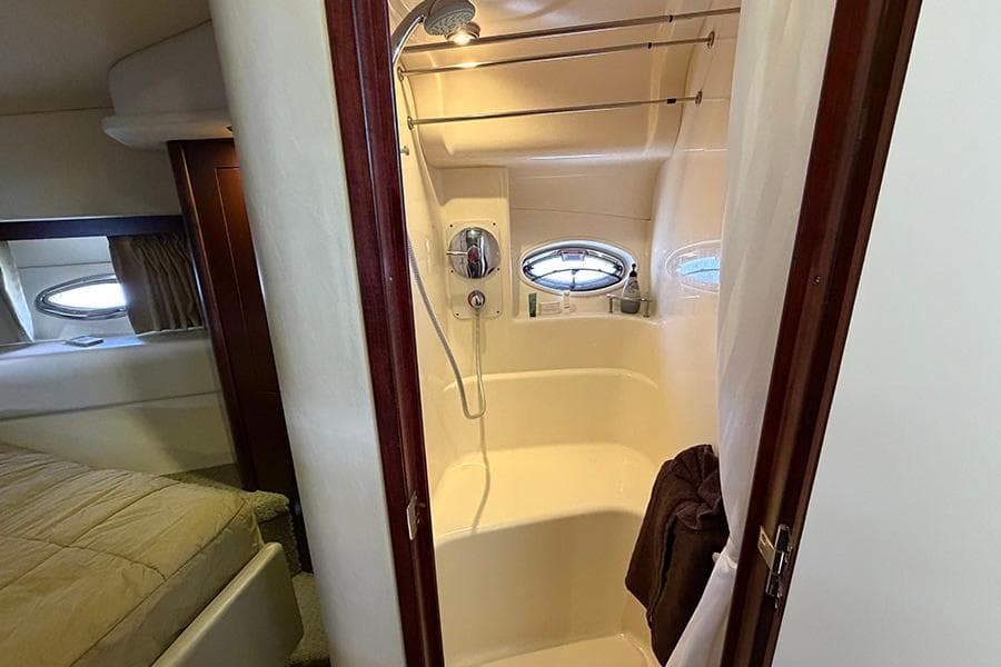 Bathroom interior of 2008 Sea Ray 36 Sedan Bridge yacht with shower and porthole windows.