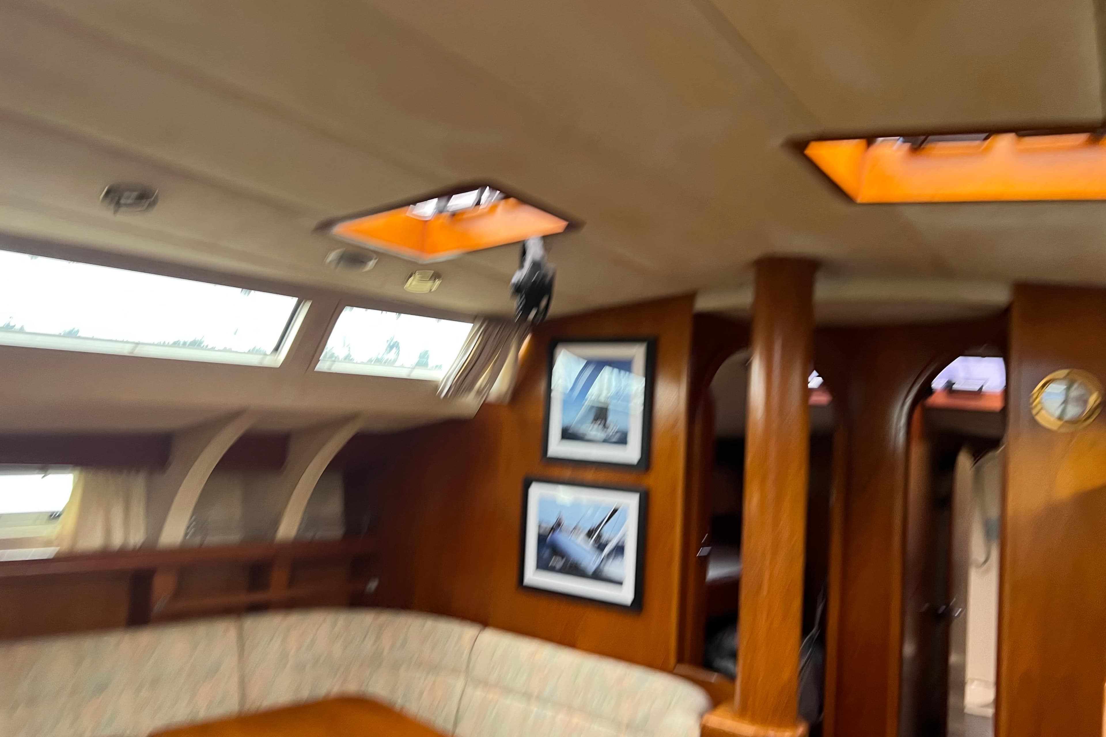 Interior of 1990 Trintella 49A yacht with wooden finish and skylights.