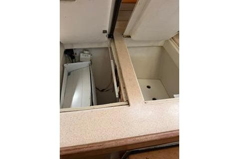 2003 Morgan/Catalina 381 CC interior storage compartments with open lids.