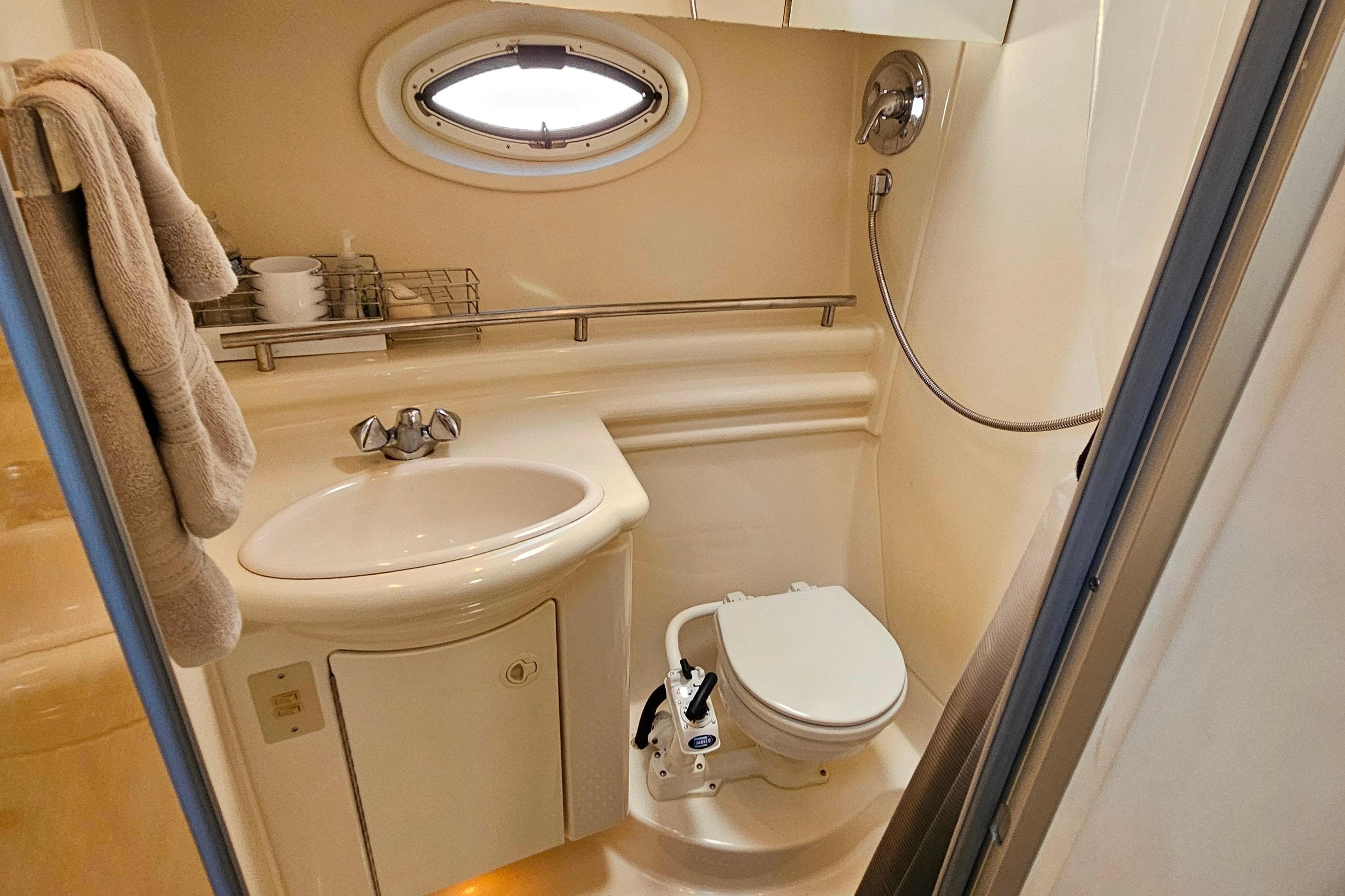 2001 Maxum 3500 SCR yacht bathroom with sink, toilet, and shower.