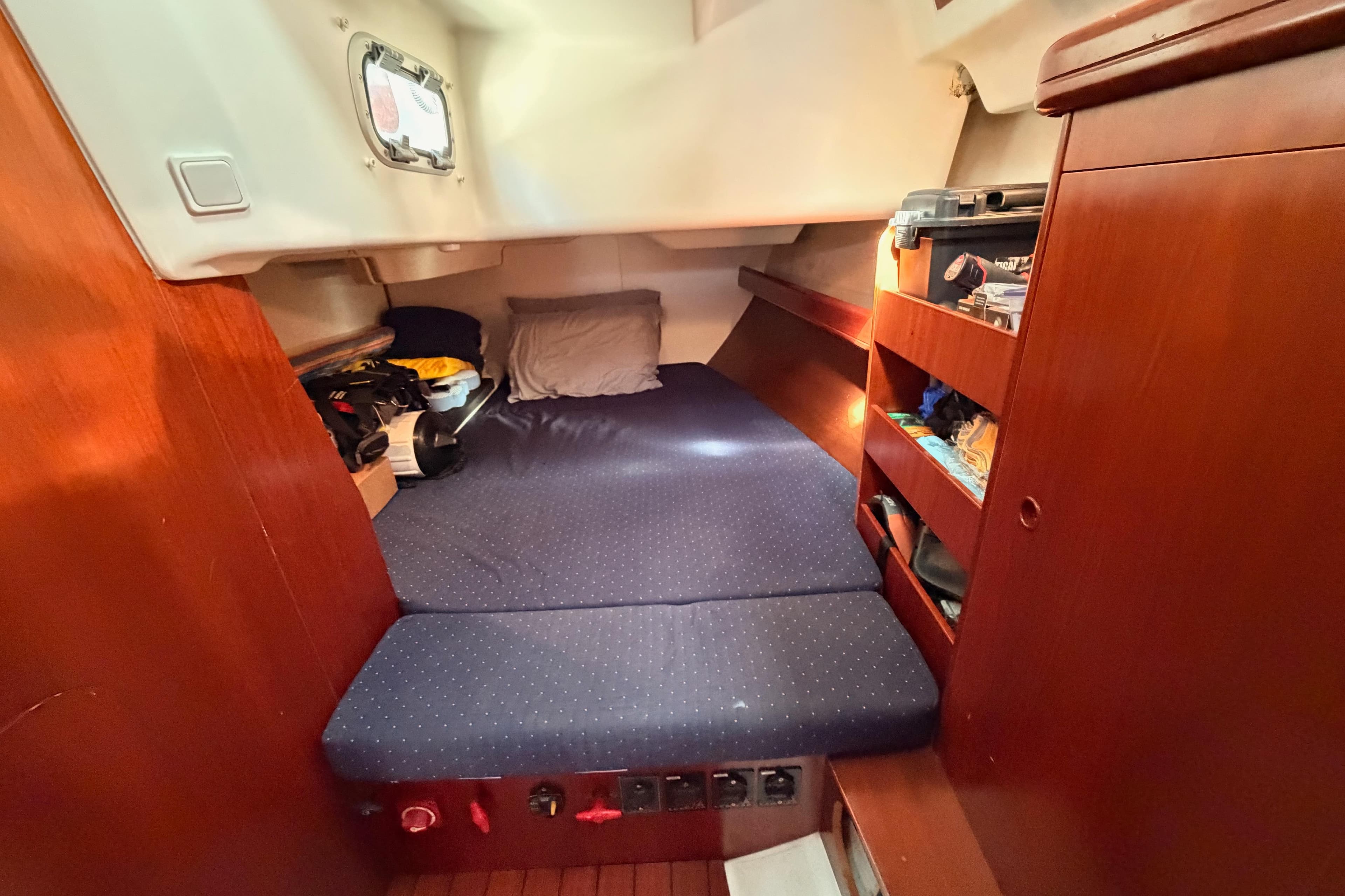 Cozy cabin interior of 2005 Beneteau Oceanis Clipper 423 sailboat with storage shelves.