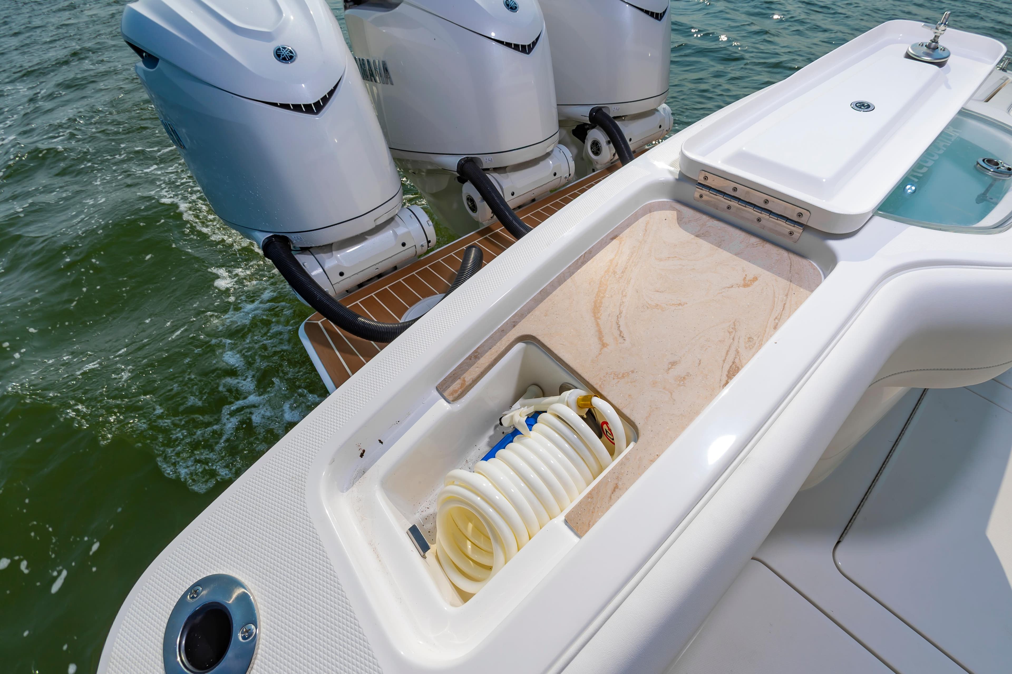 2025 Regulator 35 boat with triple engines and onboard storage compartment.
