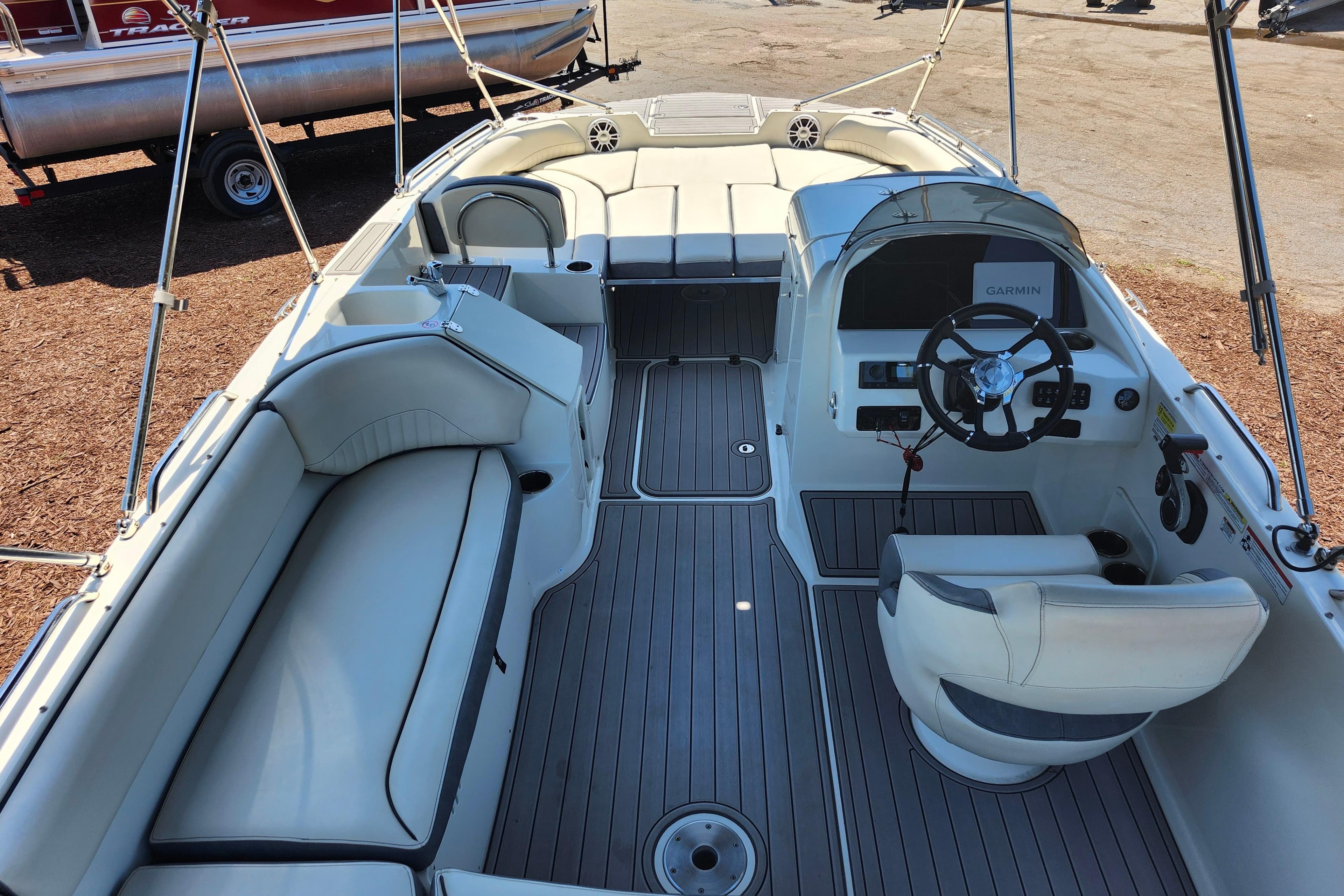2024 Stingray 212 SC boat interior with seating and steering console.